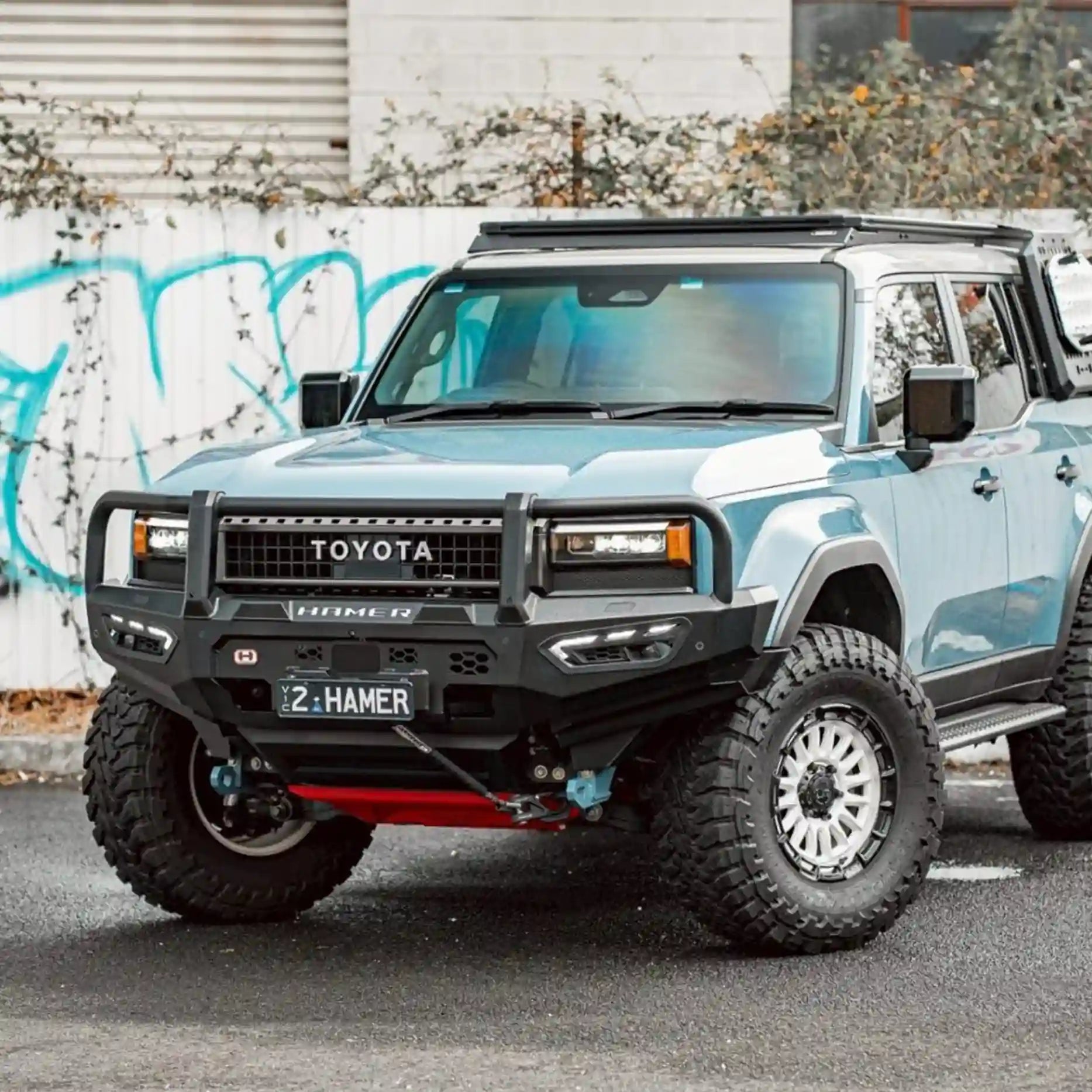 Right side profile of Atlas Plus Bull Bar for Toyota Landcruiser Prado 250 Series (2024 – Present), featuring winch lever access, recovery points, and integrated LED fog lamps.