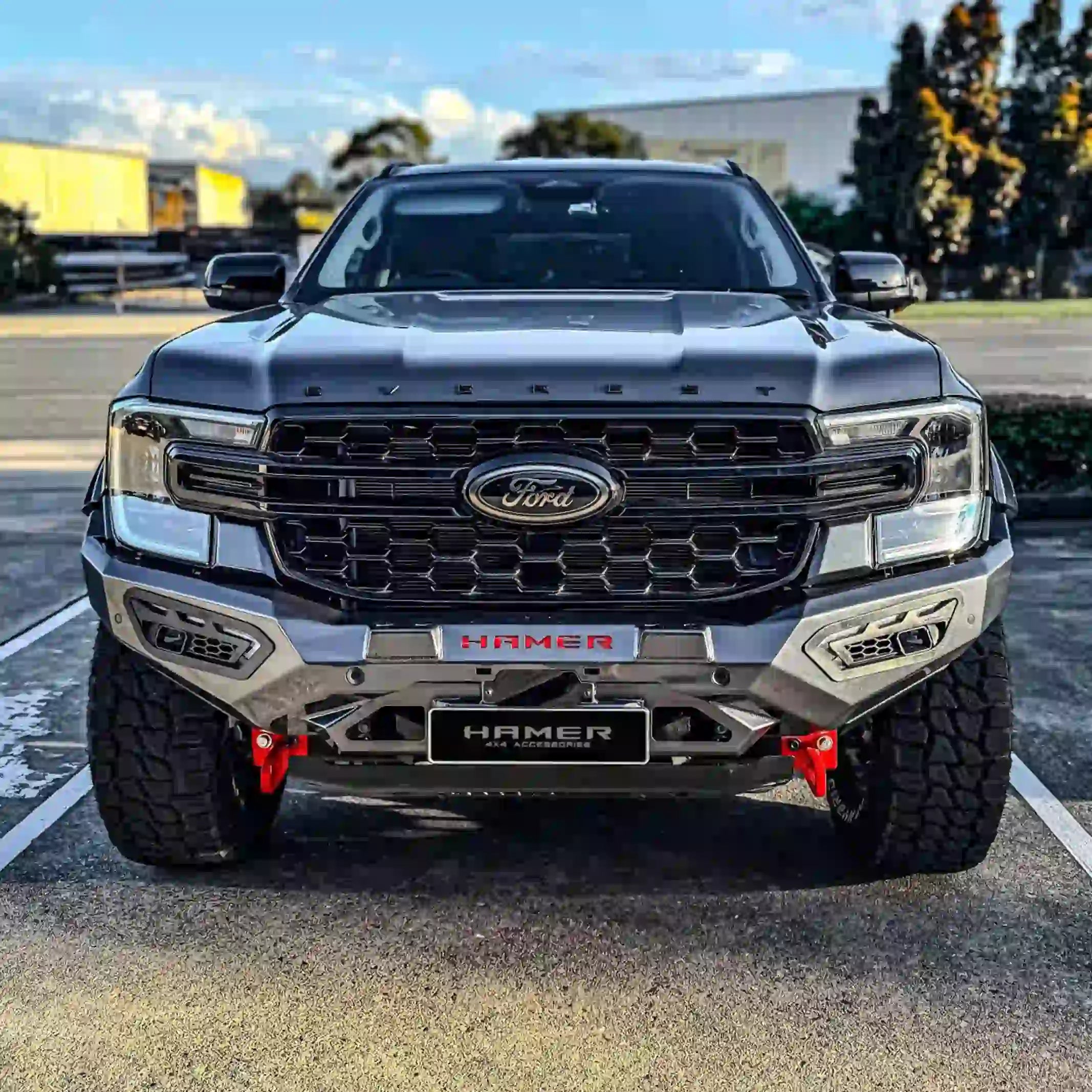 front view of ford everest 2022 equipped with atlas series bull bar in silver matte finish demonstrating sequential led lighting and bumper replacement design elevated 4x4
