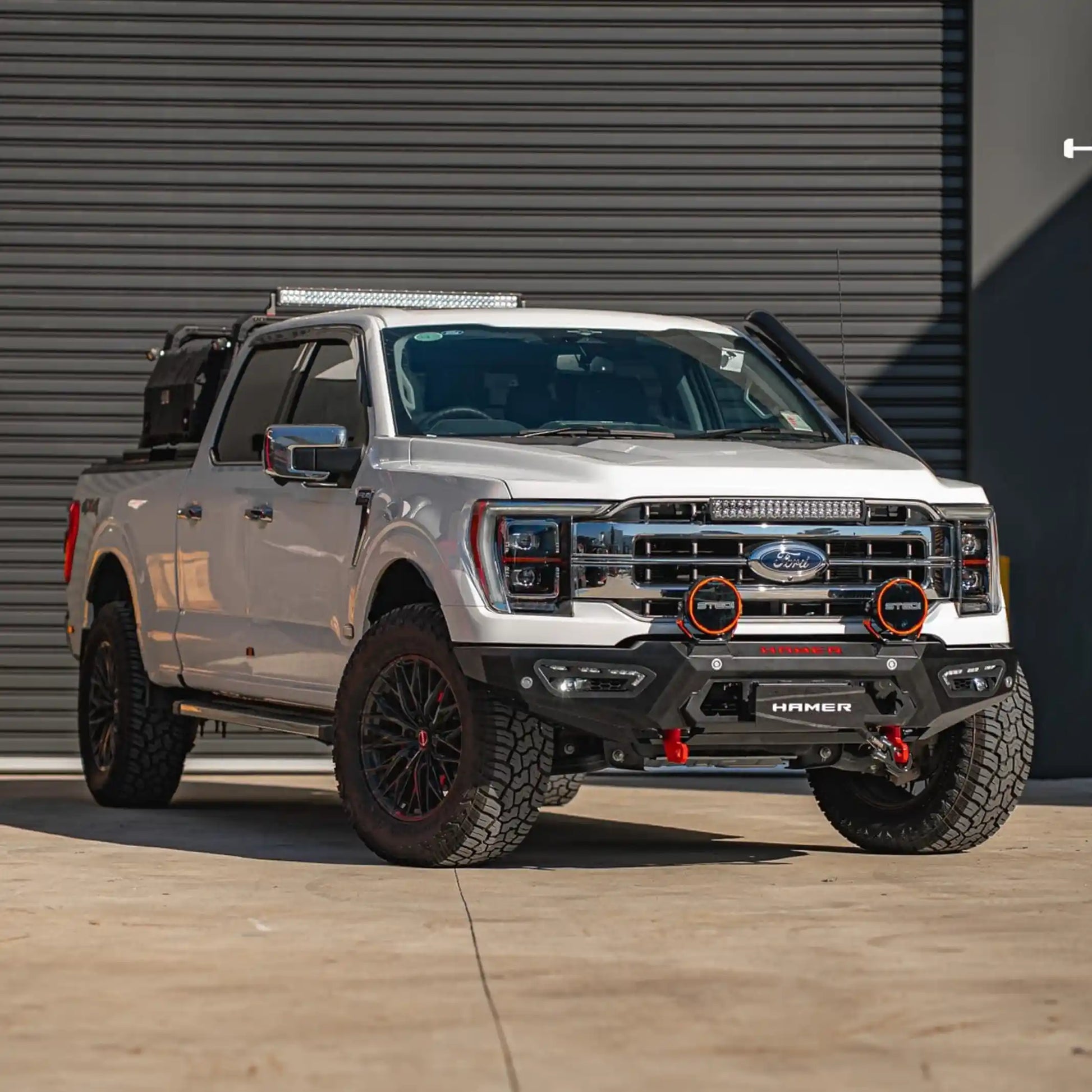 full body installed view of ford f150 equipped with atlas series bull bar highlighting aggressive styling off-road recovery points and integrated led lighting elevated 4x4