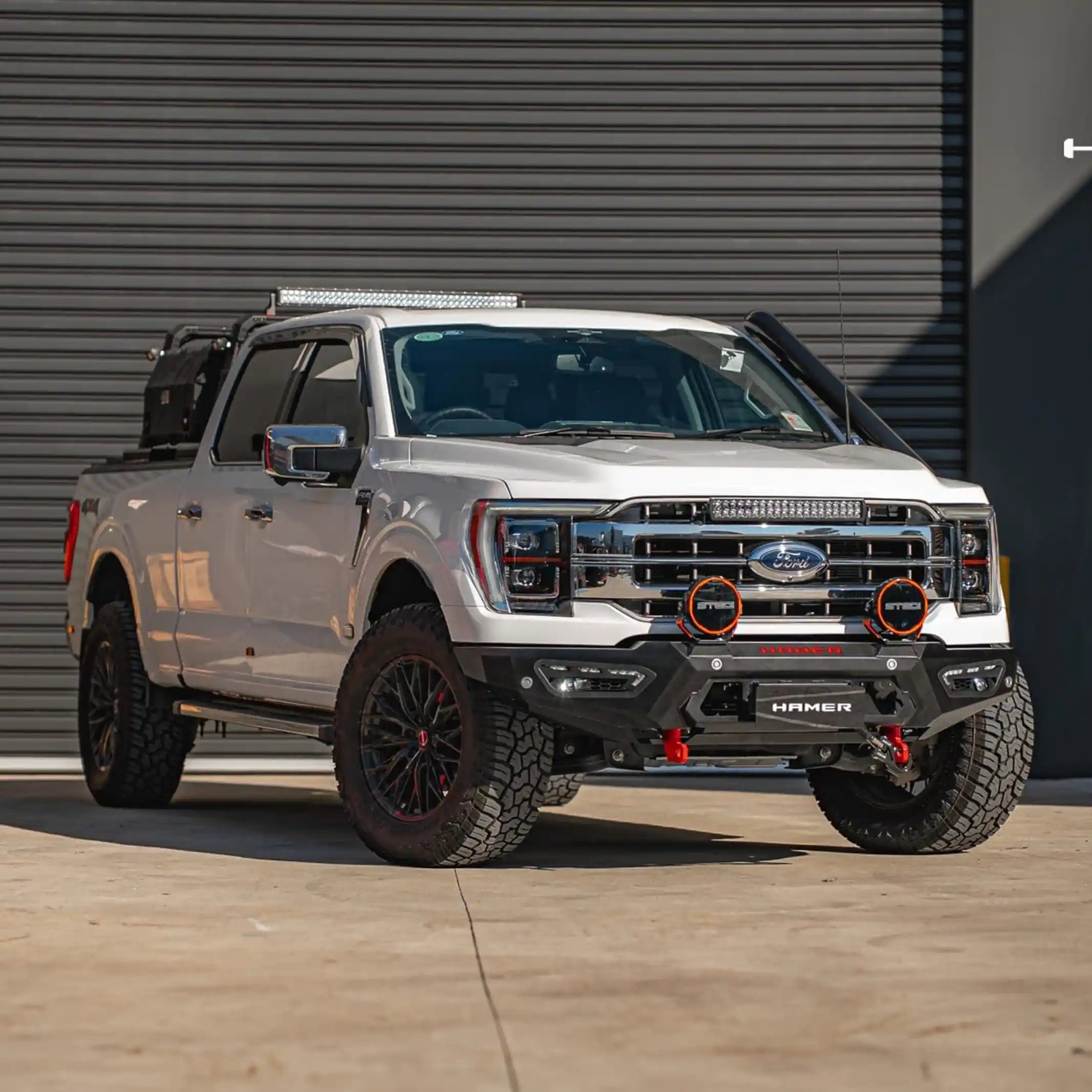 full body installed view of ford f150 equipped with atlas series bull bar highlighting aggressive styling off-road recovery points and integrated led lighting elevated 4x4