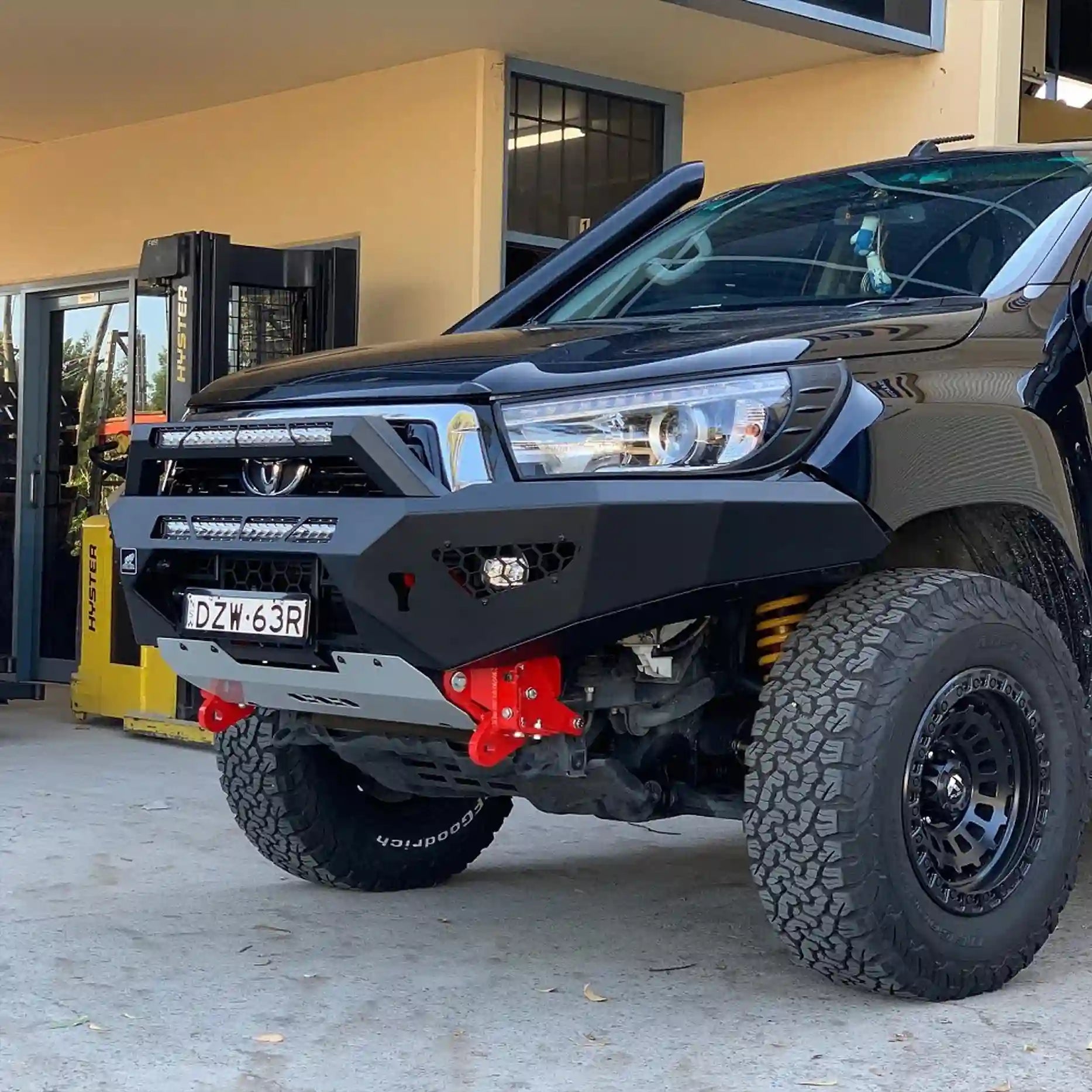 Left angle view of the Offroad Animal Predator Bull Bar on a Toyota Hilux N80, featuring its compact one-piece steel design and matte black powder coat finish. This bar by Elevated 4x4 ensures full off-road readiness while maintaining sleek aesthetics ideal for adventures through Nelson Bay and Port Stephens.