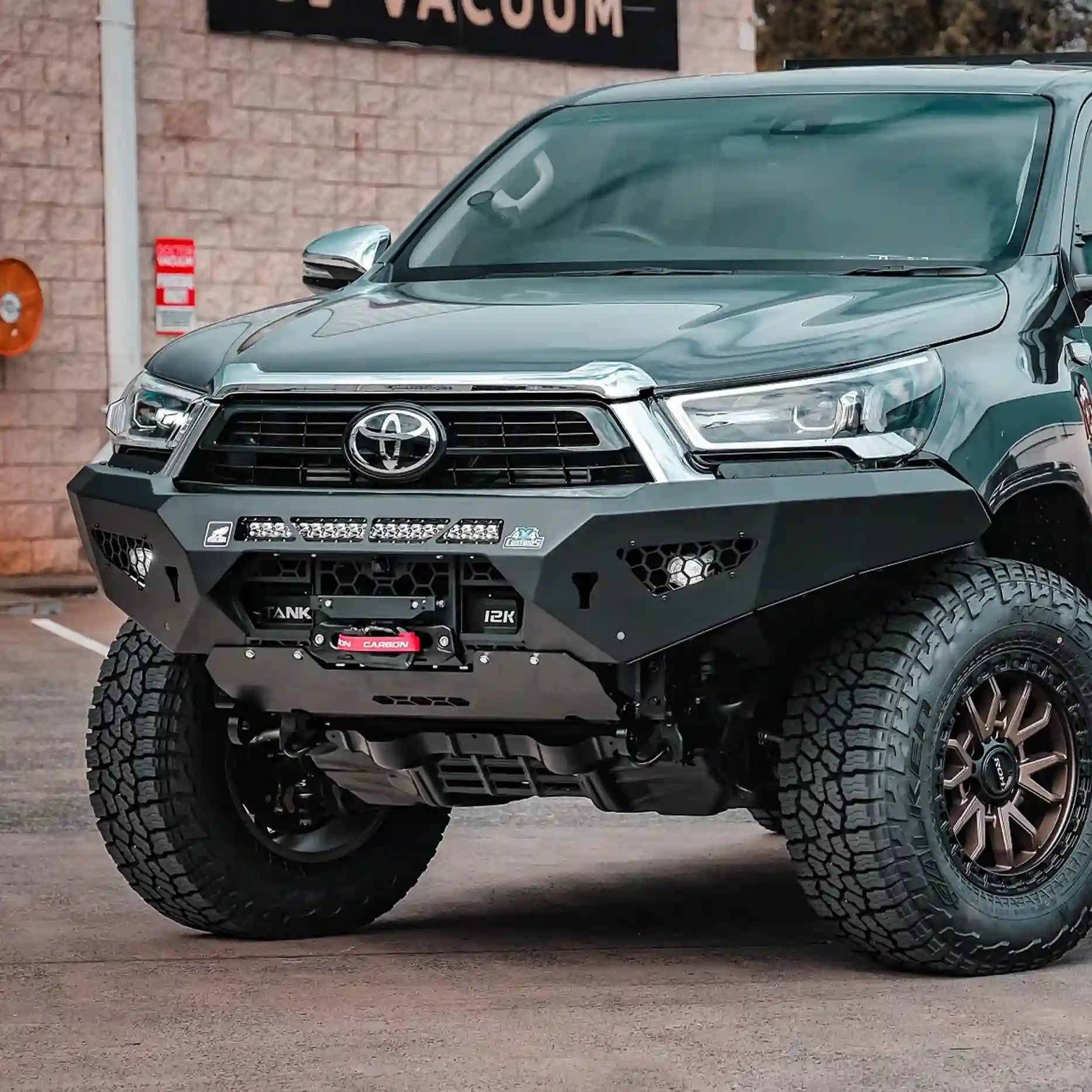 Left side view of the Offroad Animal Predator Bull Bar on a Toyota Hilux N80 MY21, featuring aerodynamic contours and factory fog light compatibility. This bar from Elevated 4x4 combines smart engineering and bold design for 4WD enthusiasts exploring Port Stephens and Nelson Bay.