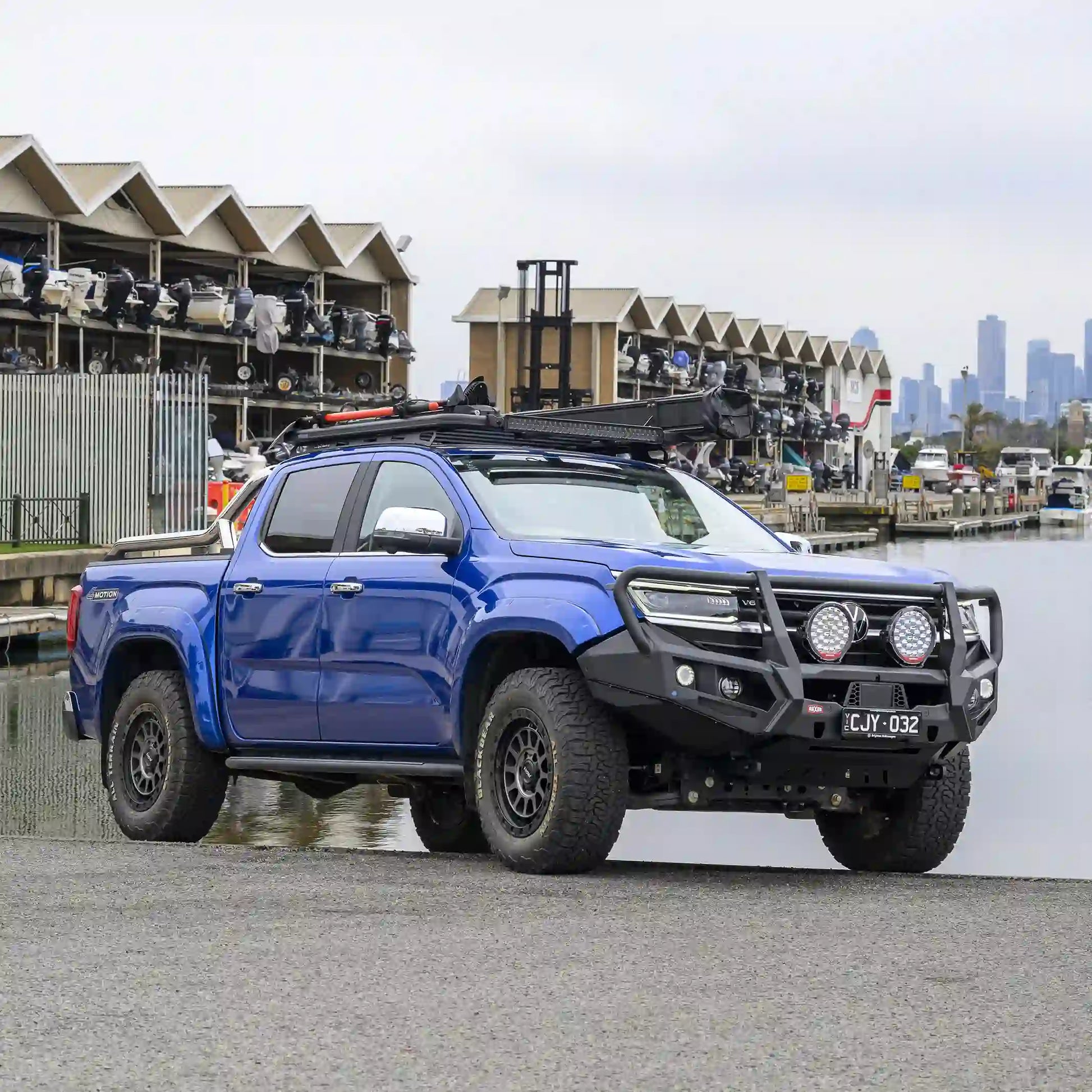 Shown from the left side, the VW Amarok installed looped bull bar from Elevated 4x4 highlights strong split-pan construction, recovery points, and underbody bash plates. Engineered by RAXAR for Australian terrain, it combines durability, style, and reliable 4WD performance for work, street, or touring.