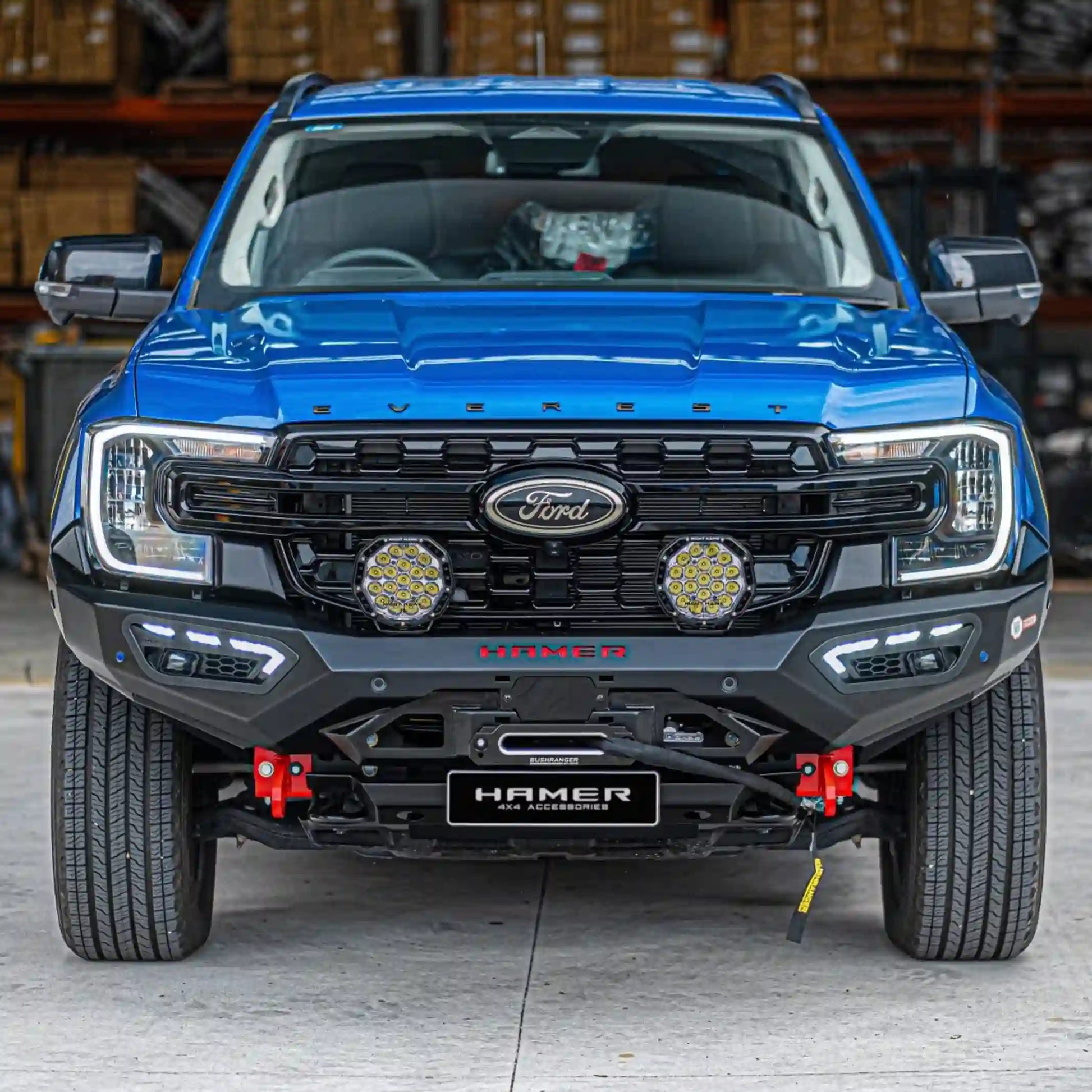 ford everest 2022 blue with atlas series bull bar front view showing adr compliant design sleek matte black finish and integrated led lighting elevated 4x4