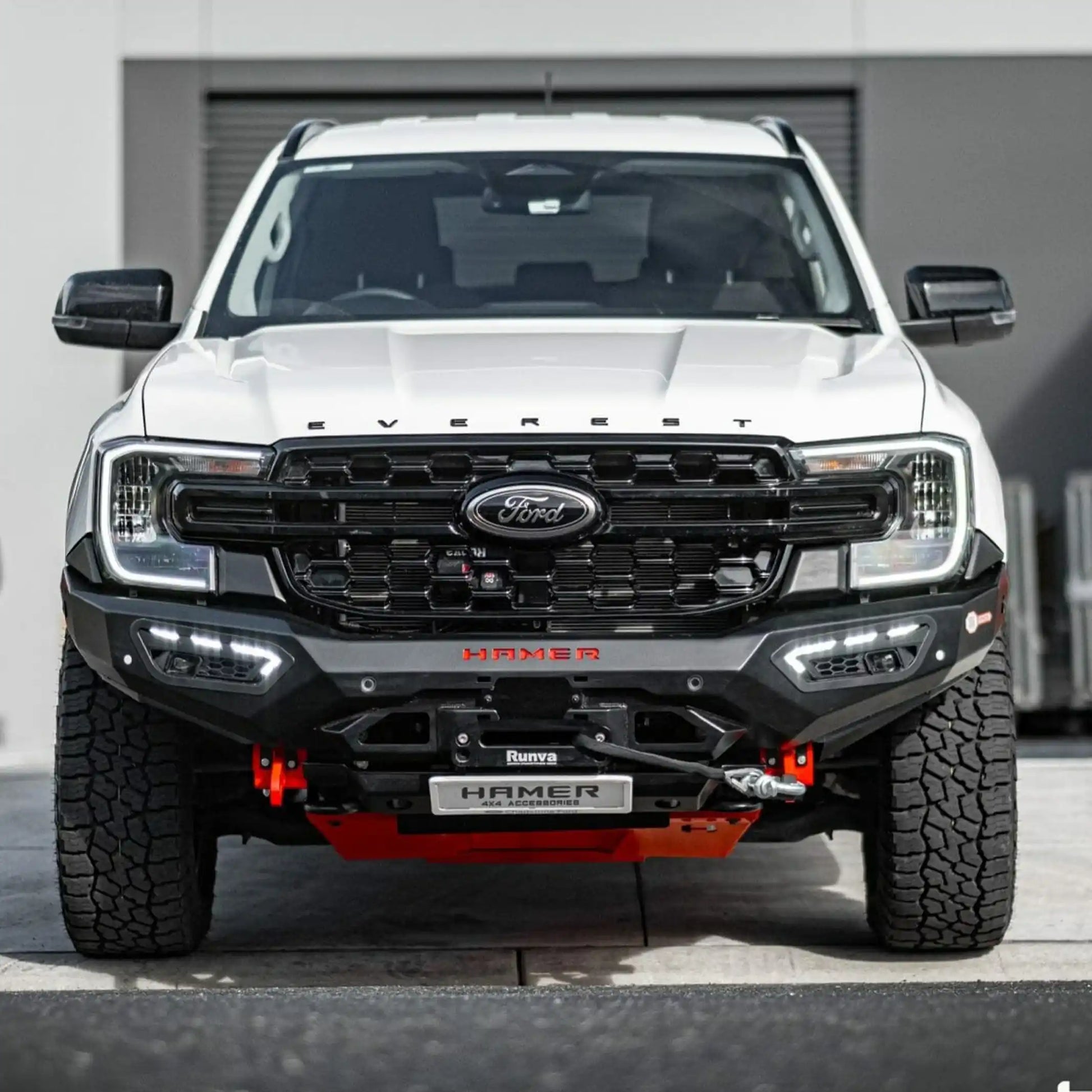 front installed view of ford everest 2022 with atlas series bull bar in white showing aerodynamic fit and led fog lamps elevated 4x4