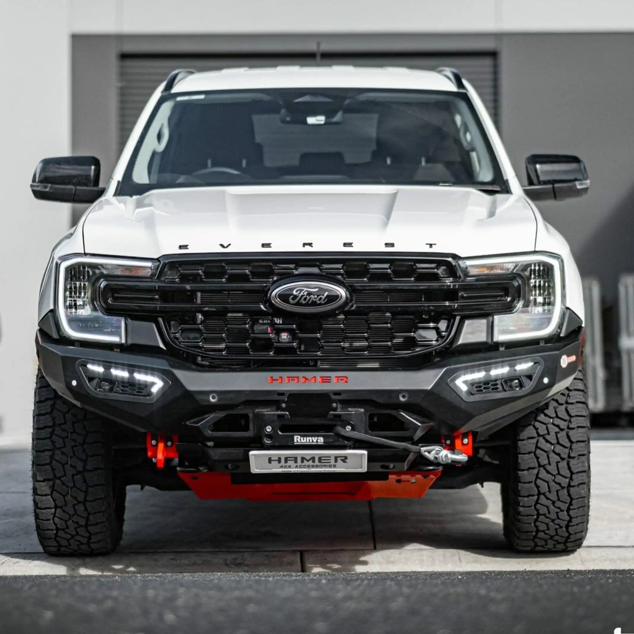 front installed view of ford everest 2022 with atlas series bull bar in white showing aerodynamic fit and led fog lamps elevated 4x4