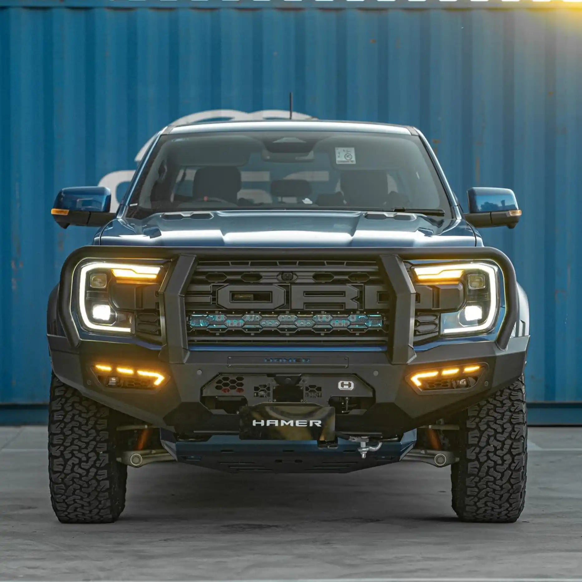 Angled front perspective of the Ford Ranger Raptor with the Hamer Atlas Series Plus Bull Bar, highlighting radar module compatibility, integrated parking sensors, and a high-quality LED lighting system.