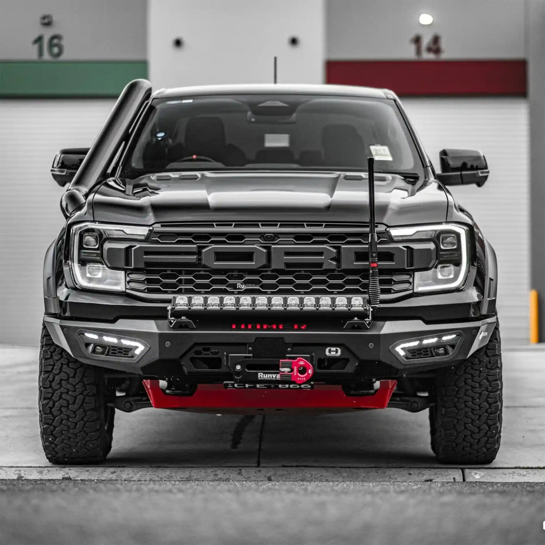 Angled front perspective of the Ford Ranger Raptor with the Hamer Atlas Series Bull Bar, highlighting its integrated LED lighting system, winch-ready design, and full bumper replacement style.