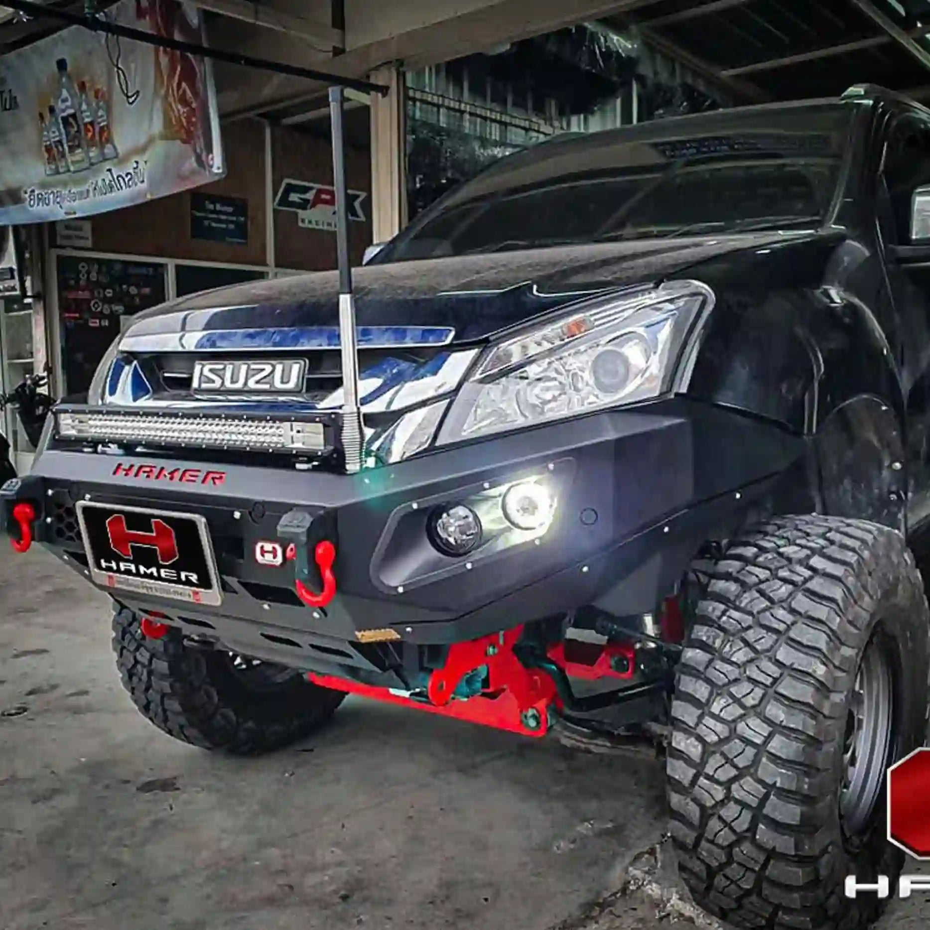 Close-up right angle of Isuzu MU-X 2012–2016 fitted with Hamer King Series Bull Bar, highlighting recovery points, winch compatibility, and LED light integration.