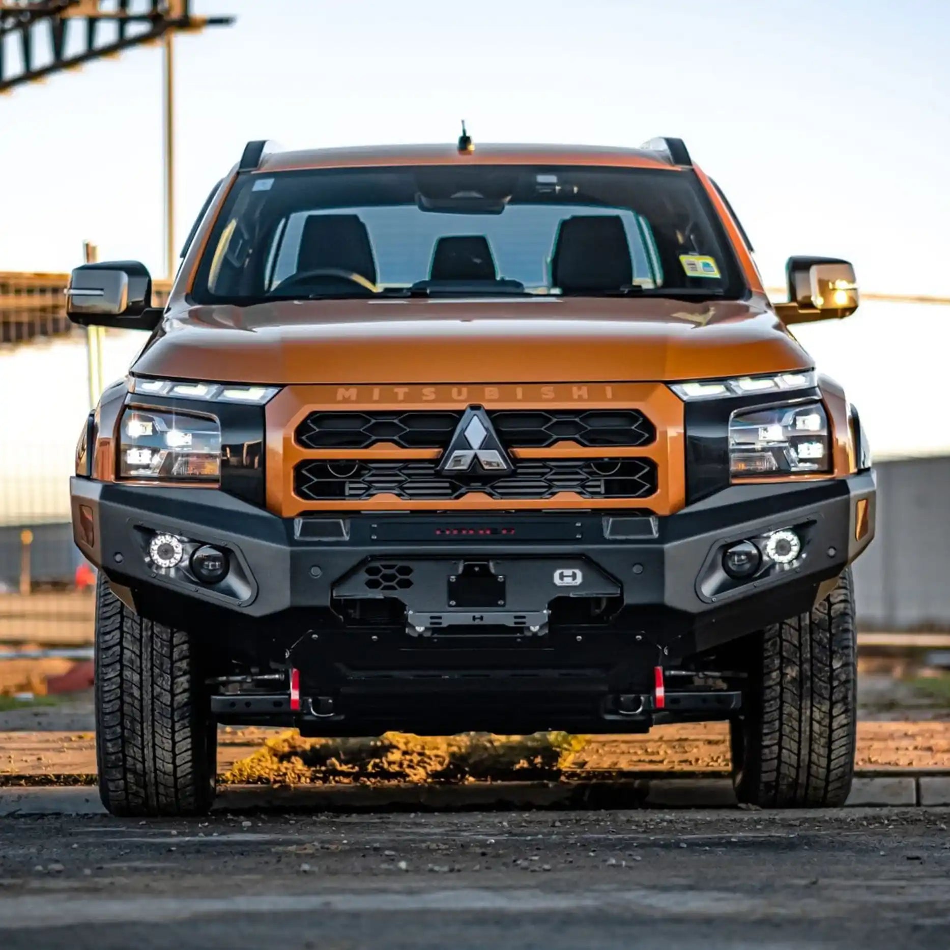 Front view of Mitsubishi Triton MV (2024–Present) fitted with Hamer King Bull Bar, a matte black bumper replacement with LED lights and recovery points.
