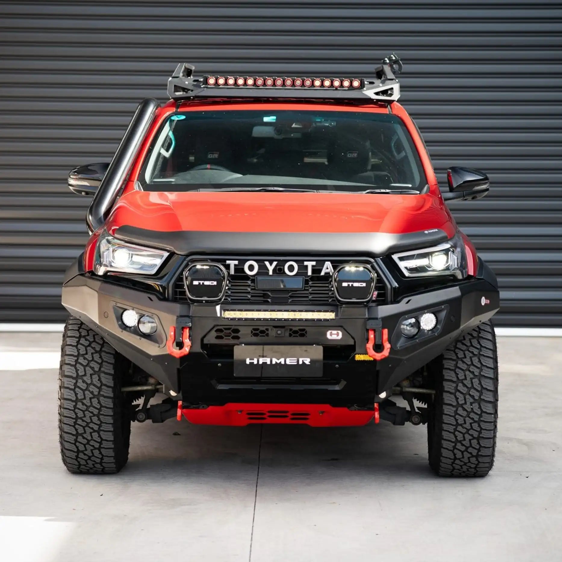 Angled front of Toyota Hilux GR (2023–Present) showing Hamer King Bull Bar, winch compatible with sleek matte black finish.