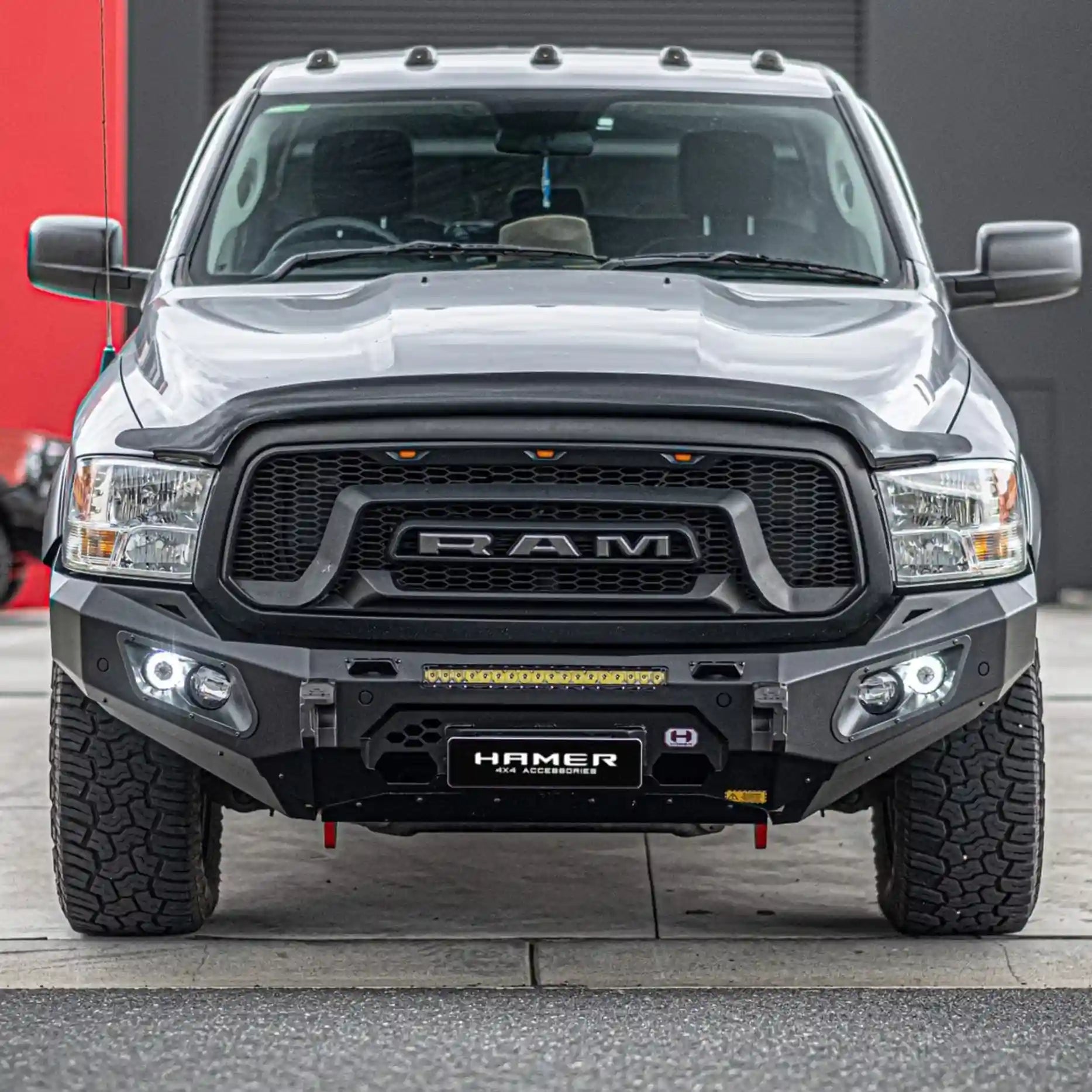 Front angle of Ram 1500 DS showing Hamer King Bull Bar with integrated LED lights and winch compatibility.