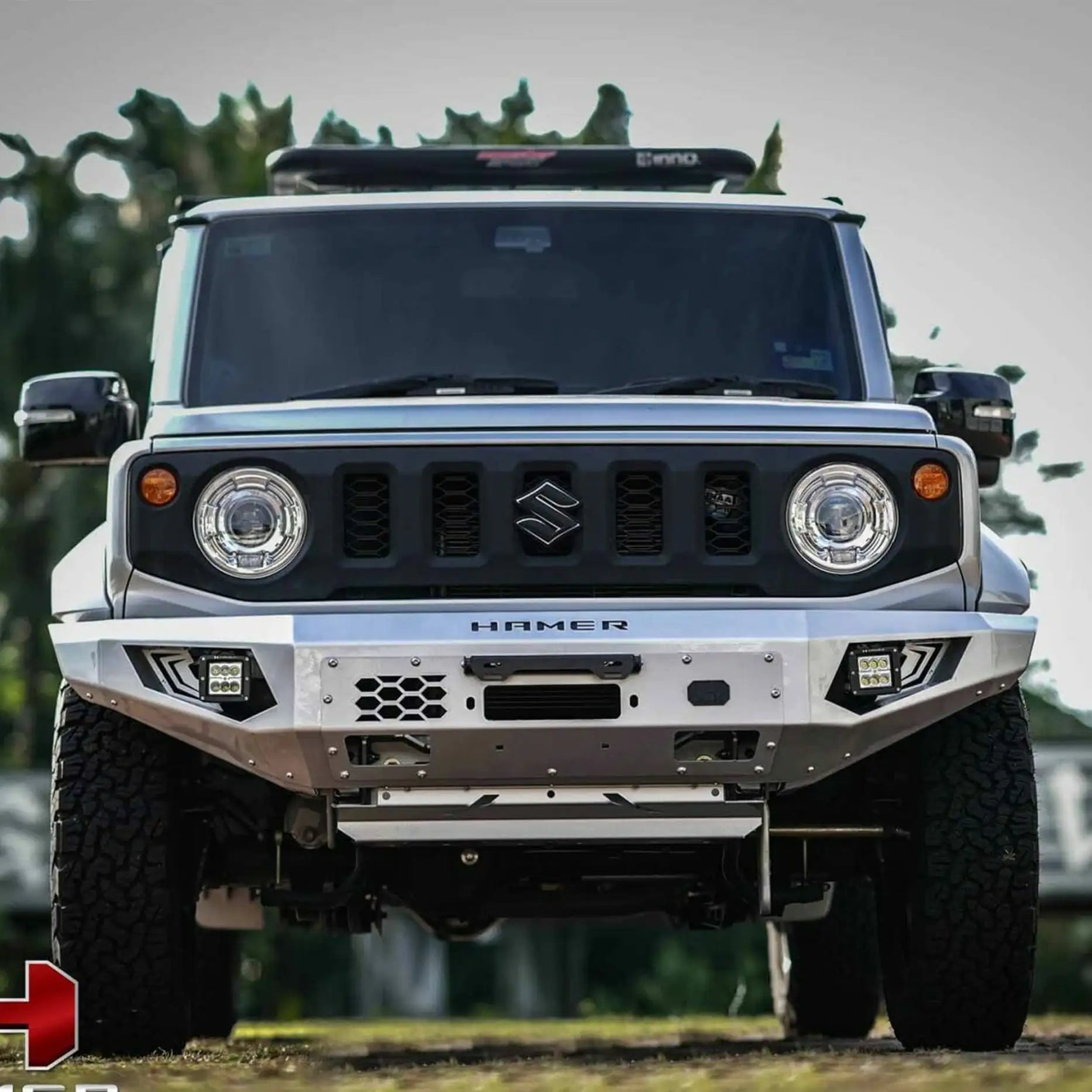 Angled front of Suzuki Jimny JB74W (2018–Present) showcasing Hamer King Bull Bar with integrated lights and winch compatibility.