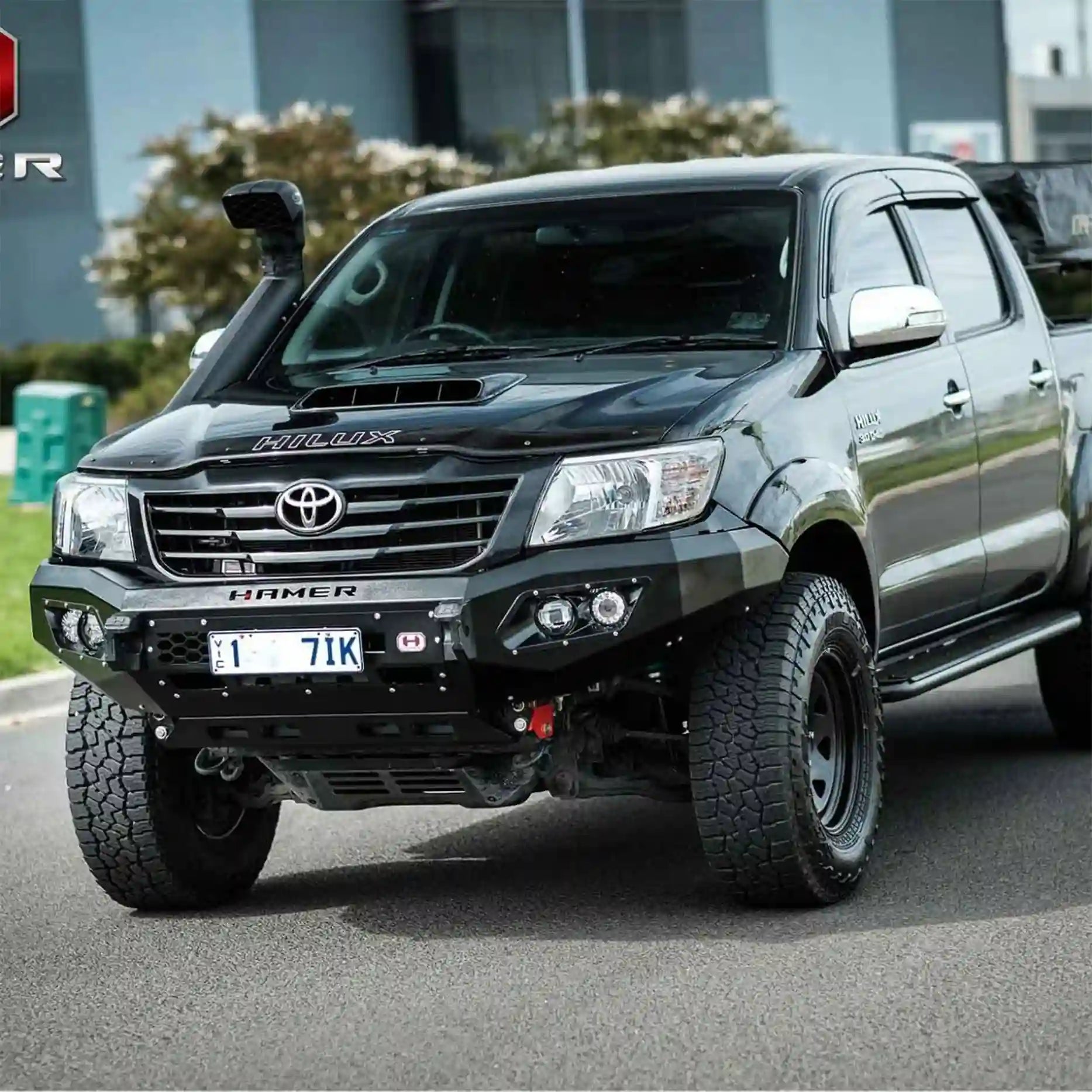 Right profile angle of Toyota Hilux 2011–2015 with Hamer King Bull Bar, matte black finish, aerial mounts, full bumper replacement.