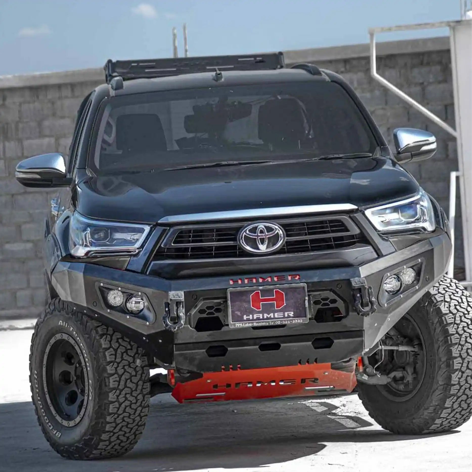 Left side of Toyota Hilux 2024 fitted with Hamer King Bull Bar, rugged matte black steel, recovery points and integrated LED lighting.