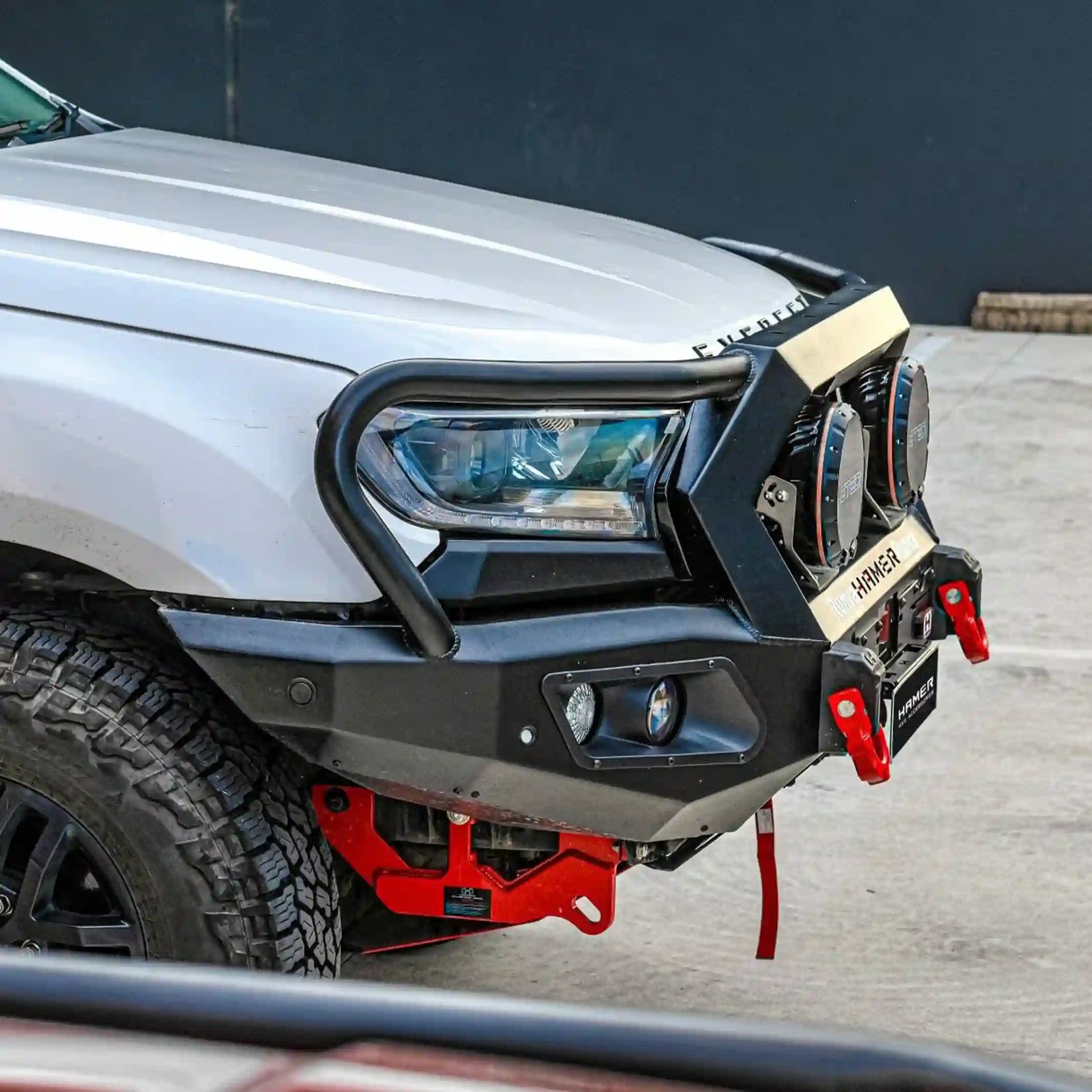 Close-up left installed view of the Hamer King Series Plus Bull Bar on a Ford Everest (2015–2022) by Elevated 4x4. This off-road accessory emphasizes sleek integration with the vehicle, matte black powder coating, full bumper replacement design, and mounting points for extra lights, offering both rugged protection and stylish Australian engineering for every journey.