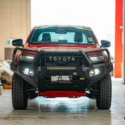 Angled front of Toyota Hilux GR (2023–Present) featuring Hamer King Plus Bull Bar, rugged matte black bumper replacement with recovery points.