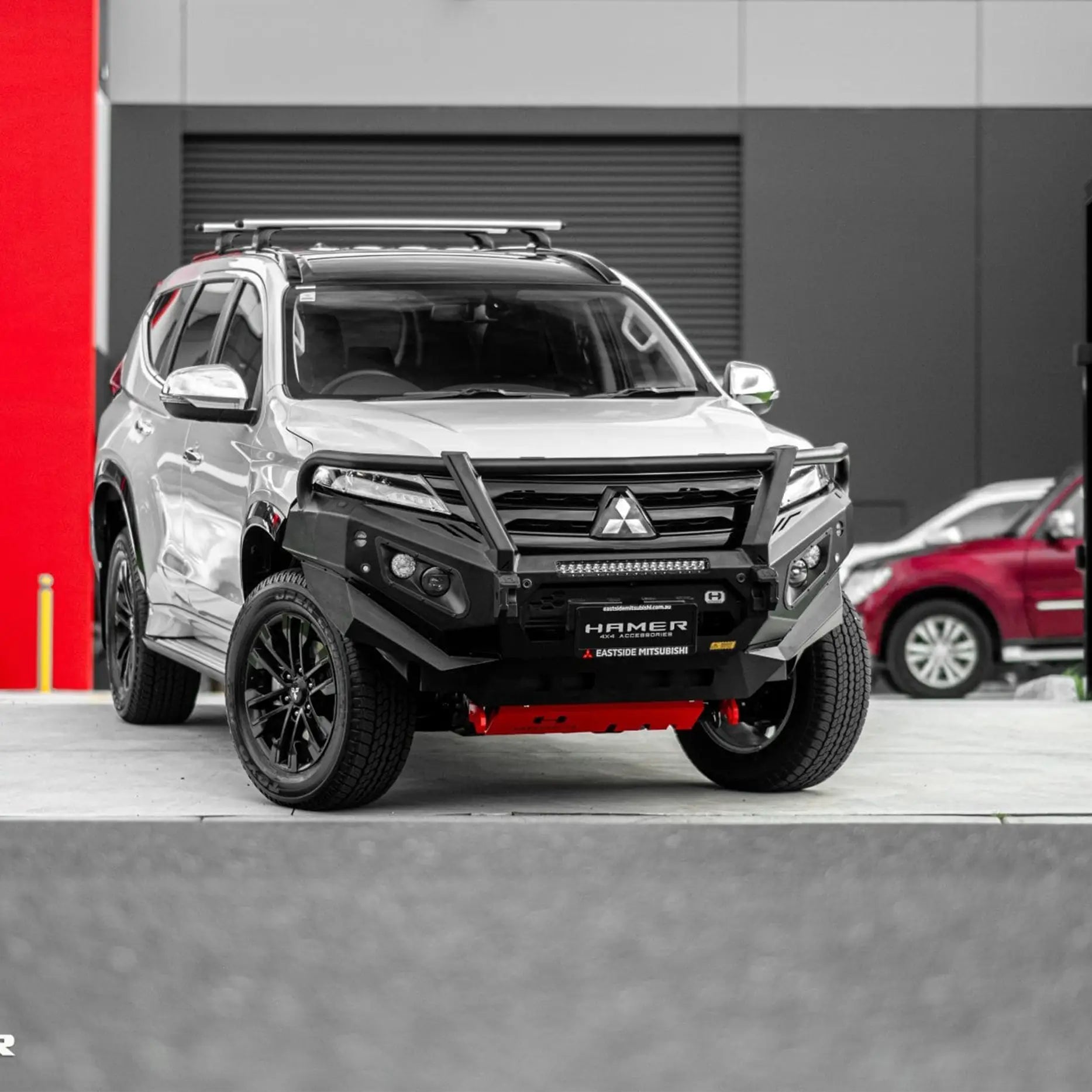 Left side view of Pajero Sport QG with Hamer King Plus Bull Bar, bold matte black finish, LED indicators, and durable off-road build.