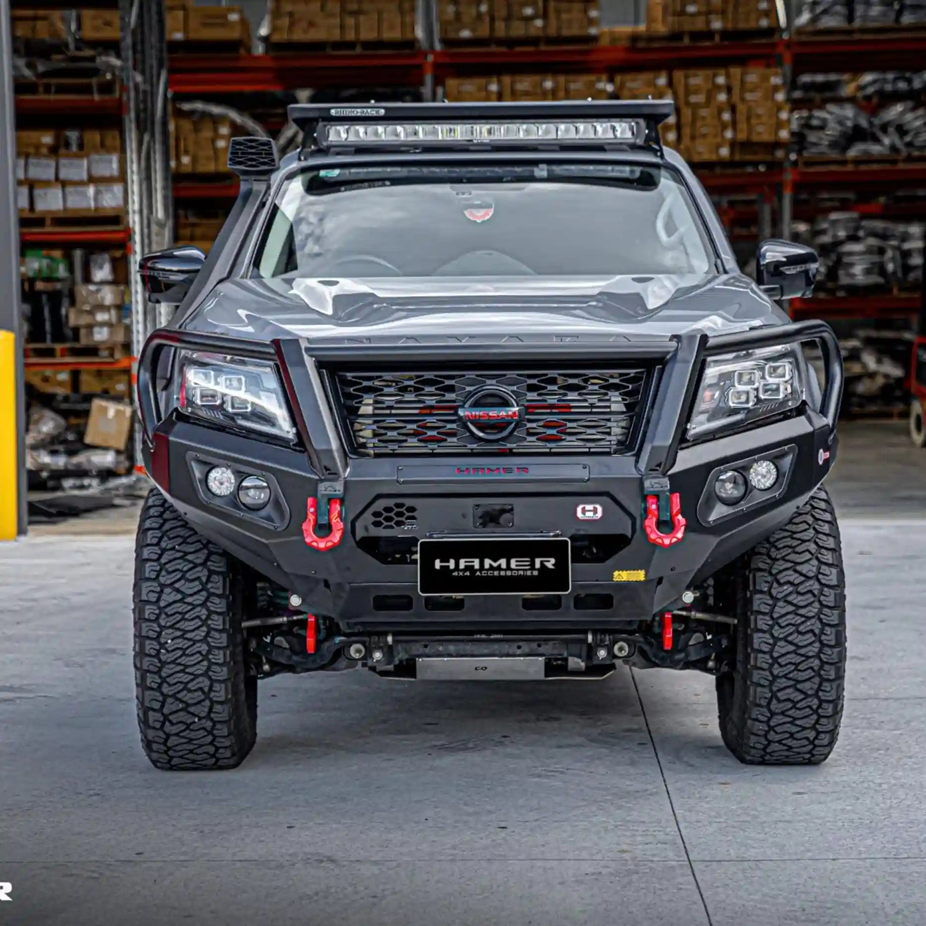 Angled front shot of Nissan Navara fitted with Hamer King Plus Bull Bar, ADR compliant steel bar with winch and radar module compatibility.