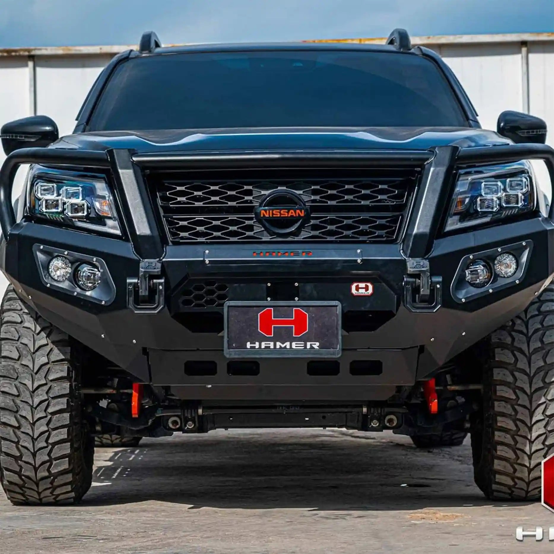 Close front detail of Hamer King Plus Bull Bar on Navara 2021, showing rugged matte finish, light bar slot and high-quality LED fog lamps.
