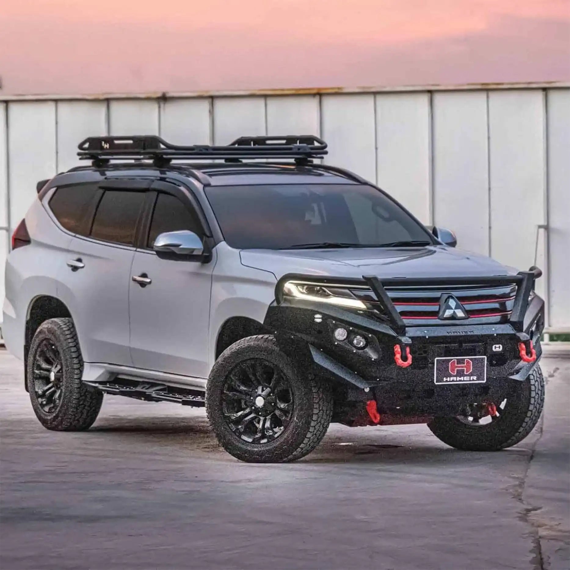 Left side angle of Pajero Sport QF fitted with Hamer King Plus Bull Bar, rugged steel bumper with LED lighting and stylish finish.
