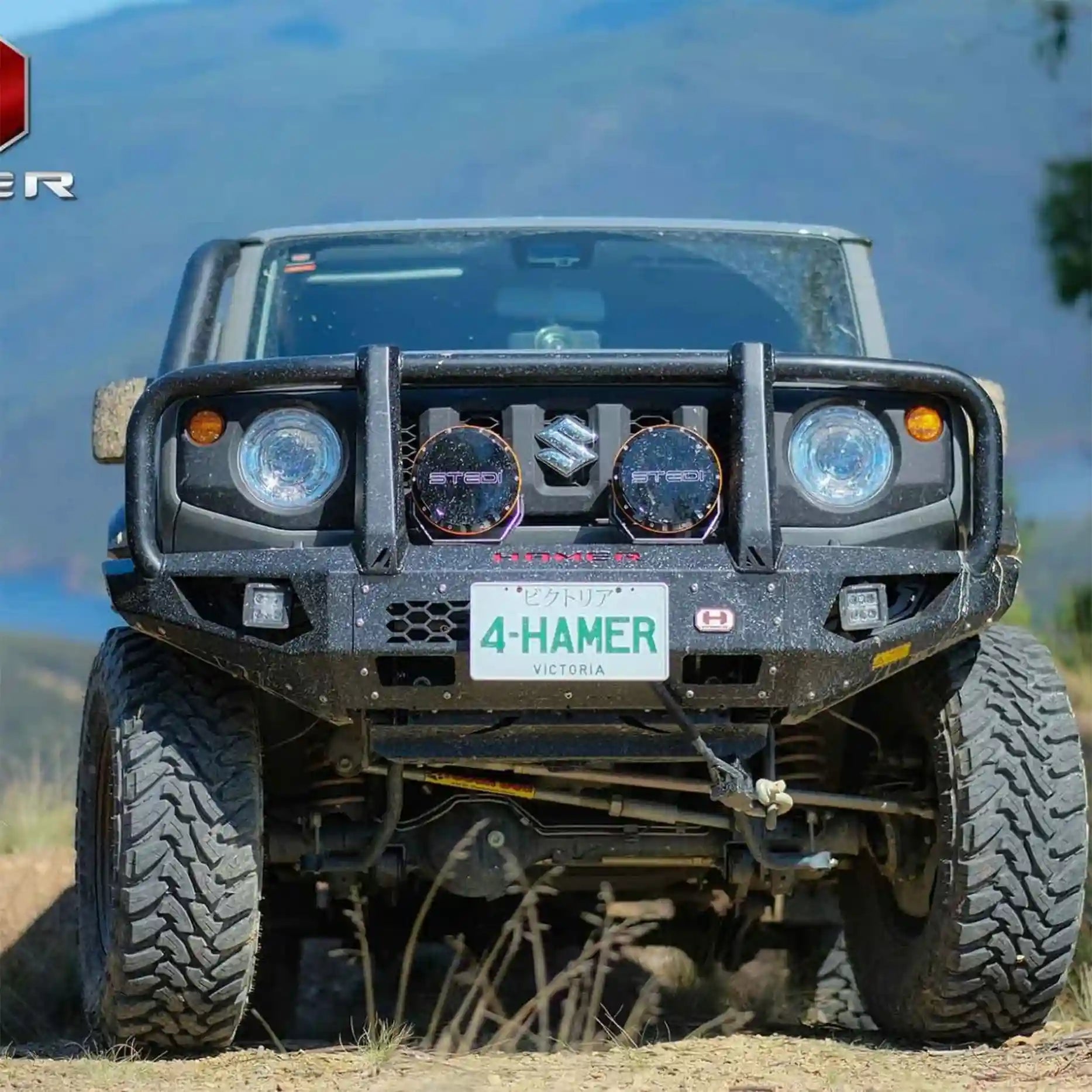 Angled front shot of Jimny JB74W fitted with Hamer King Plus Bull Bar, rugged 3mm steel design with winch compatibility up to 12,000 lb.