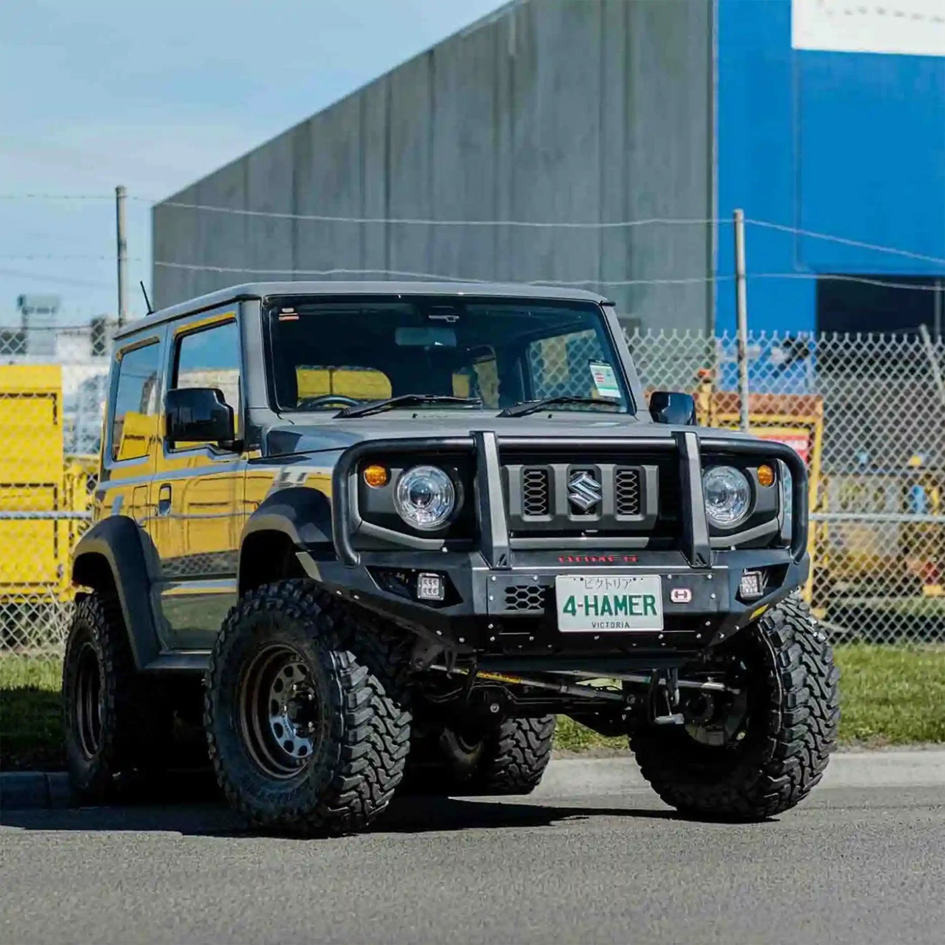 Left side view of Suzuki Jimny JB74W showcasing Hamer King Plus Bull Bar, sleek integrated style with splash guards and aerial mounts.