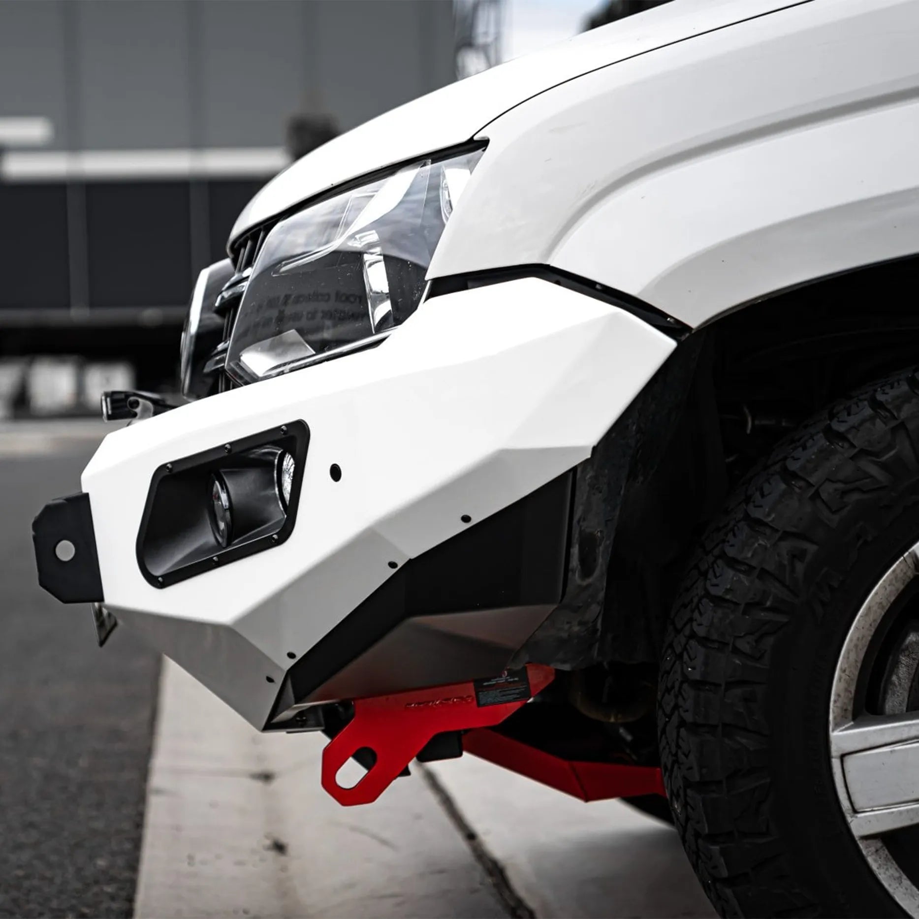 Right-side profile of Volkswagen Amarok with Hamer King Series Bull Bar, featuring integrated light bar slot and number plate flip for winch users.