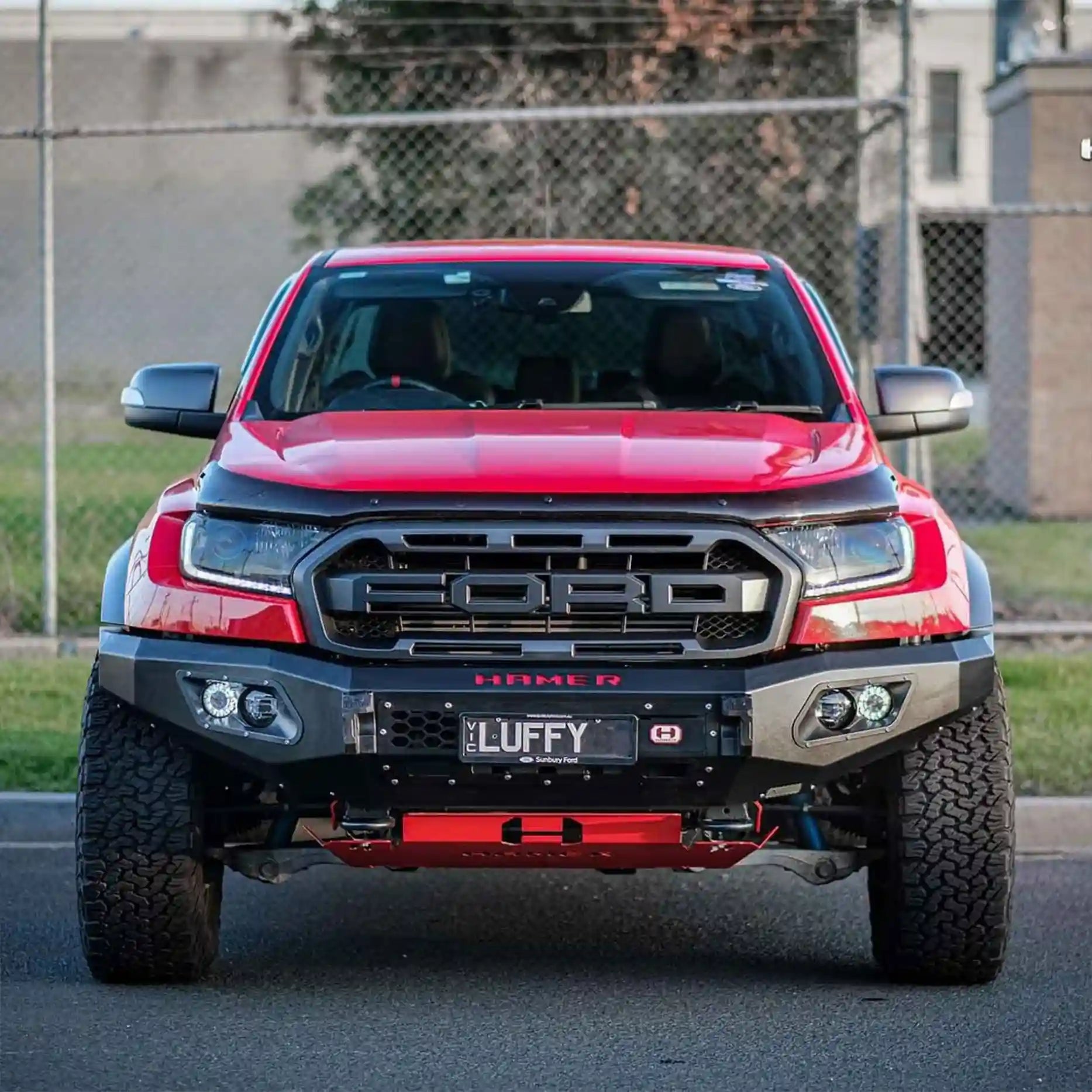 Front view of Ford Ranger Raptor 2018–2022 fitted with Hamer King Series Bull Bar, featuring matte black powder coat finish, ADR compliant design, and integrated LED lighting.