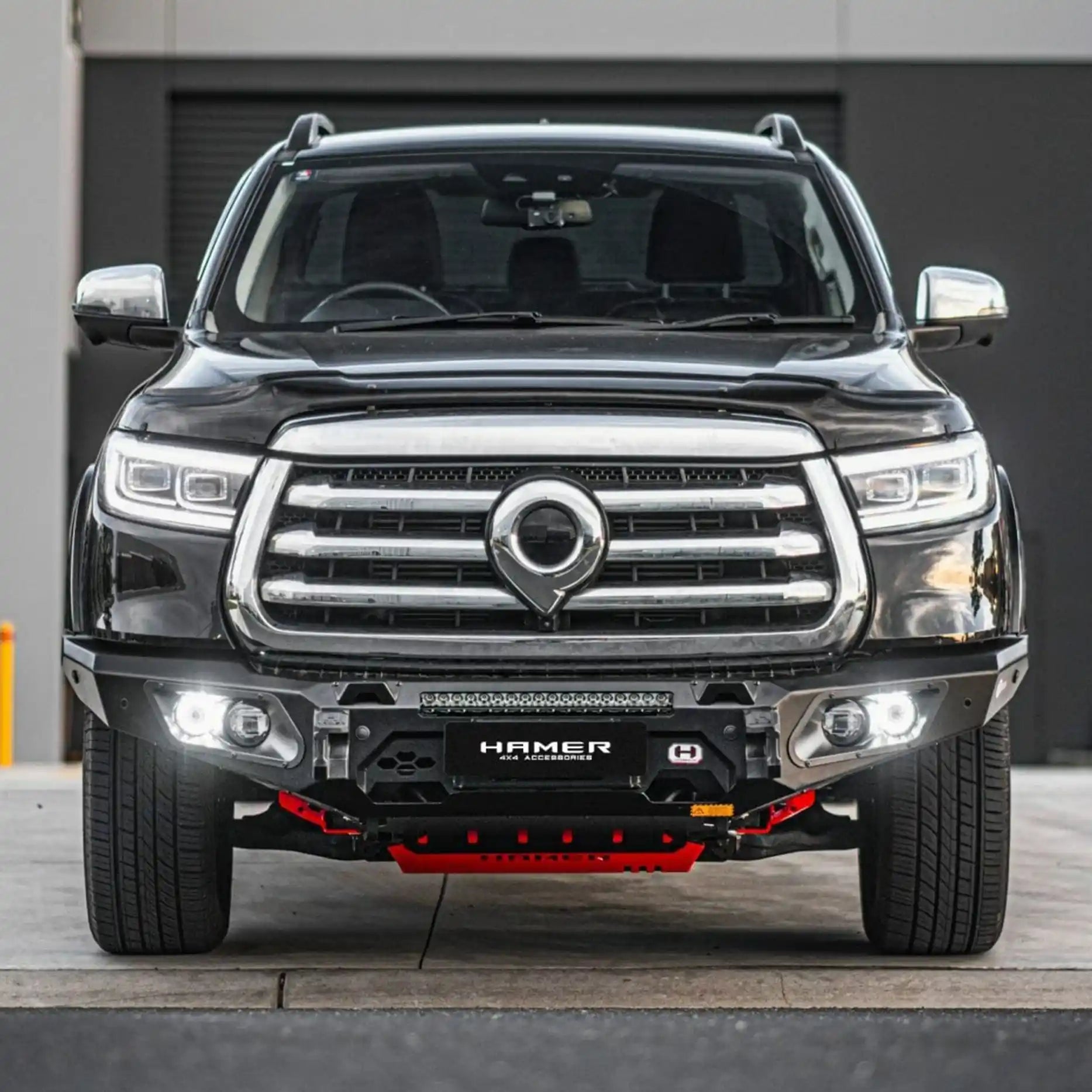 Angled front profile of GWM Cannon King Series Bull Bar, highlighting sleek matte black finish, rated recovery points, and winch compatibility up to 12,000 lb.