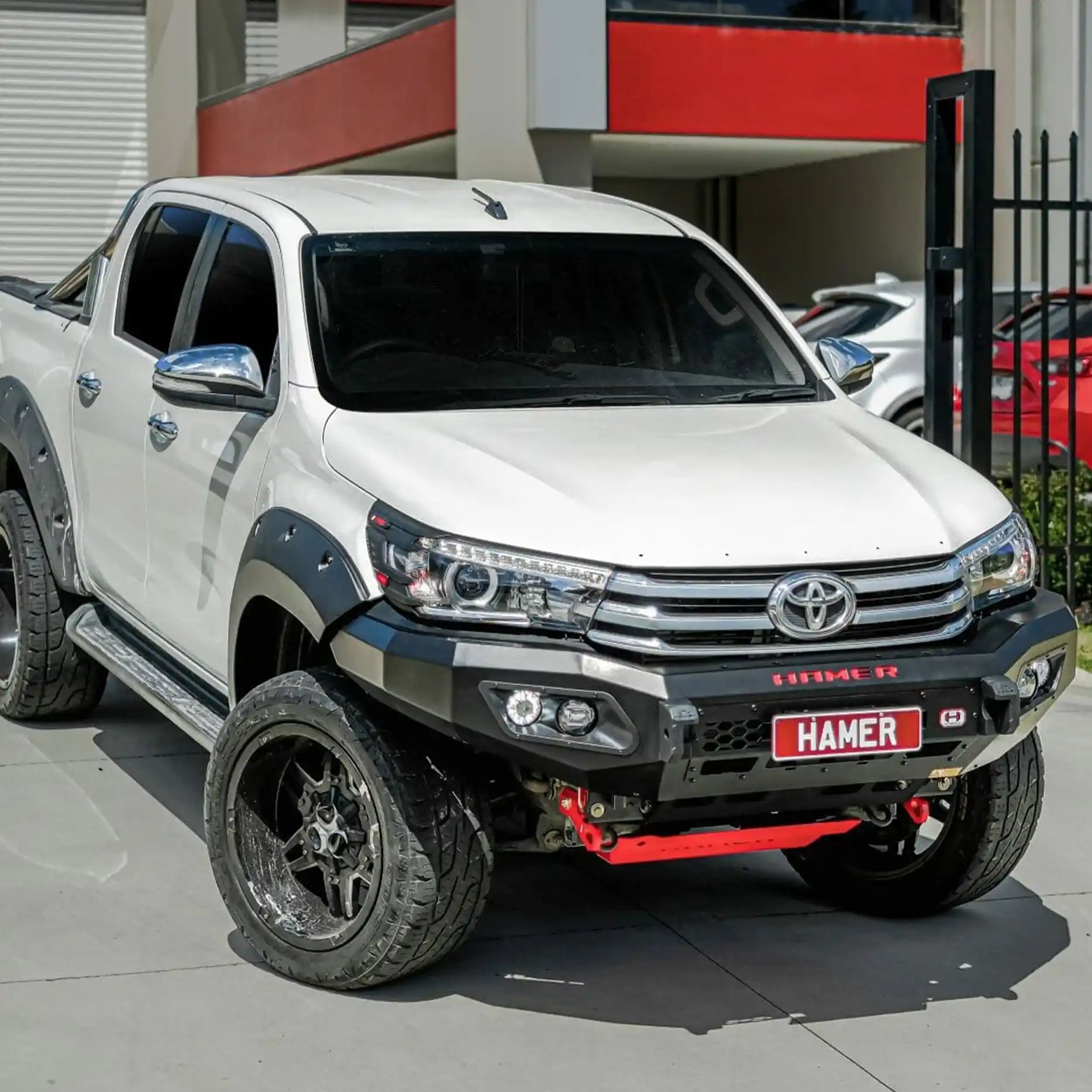 Left side of Toyota Hilux 2015–2018 showing Hamer King Bull Bar, sleek bumper replacement with light mounts and rugged matte finish.