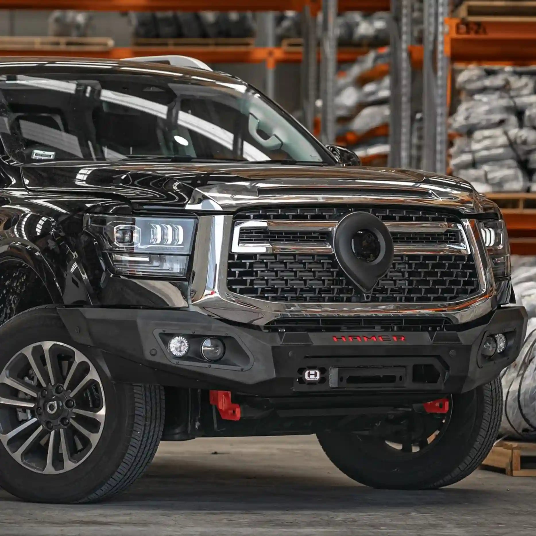 Left angled view of GWM Cannon Alpha 2024 Hamer King Bull Bar, showing sleek matte black finish, rated recovery points, and winch compatibility up to 12,000 lb.