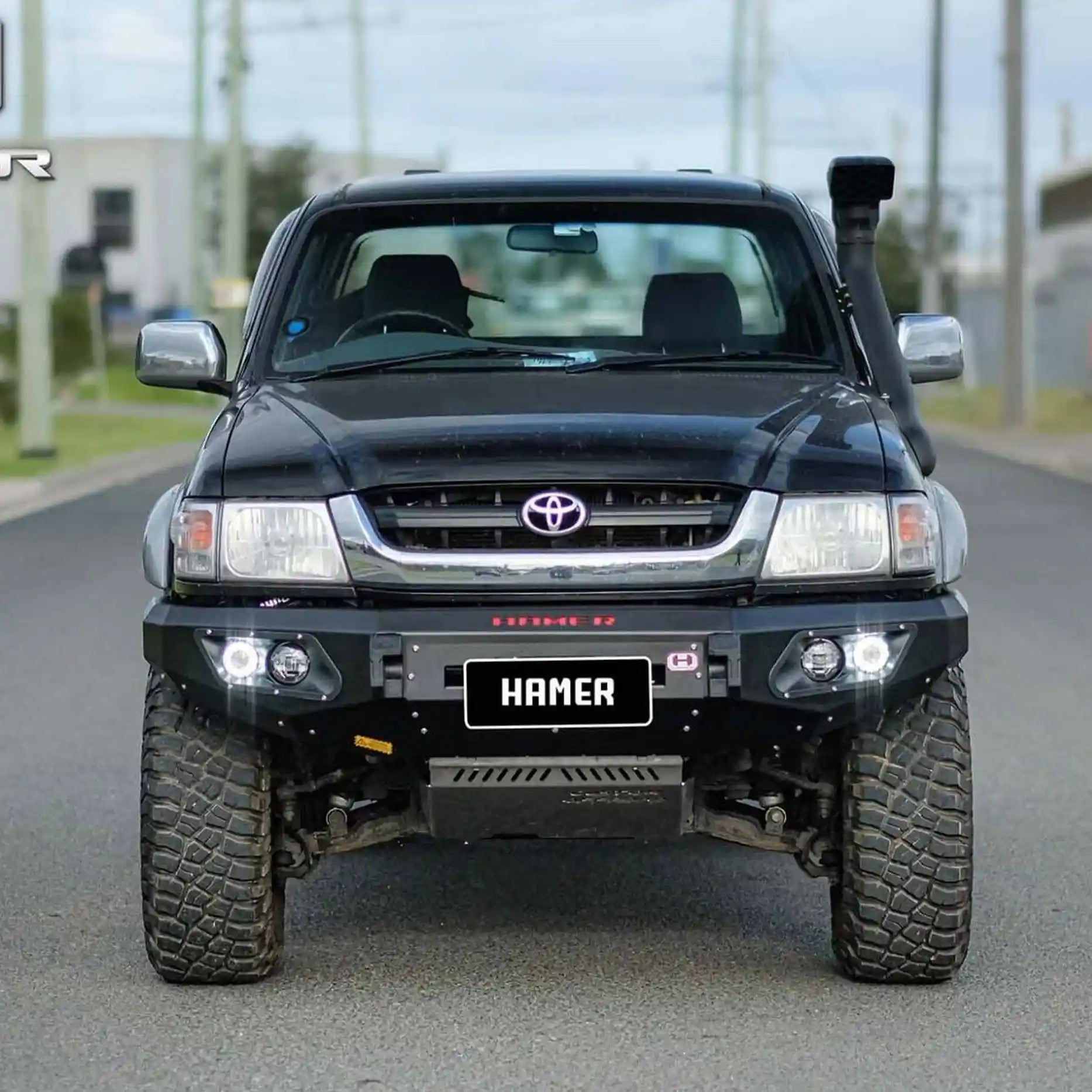 Front angle of Hilux 1997–2005 fitted with Hamer King Bull Bar, full bumper replacement, winch ready with lighting system.