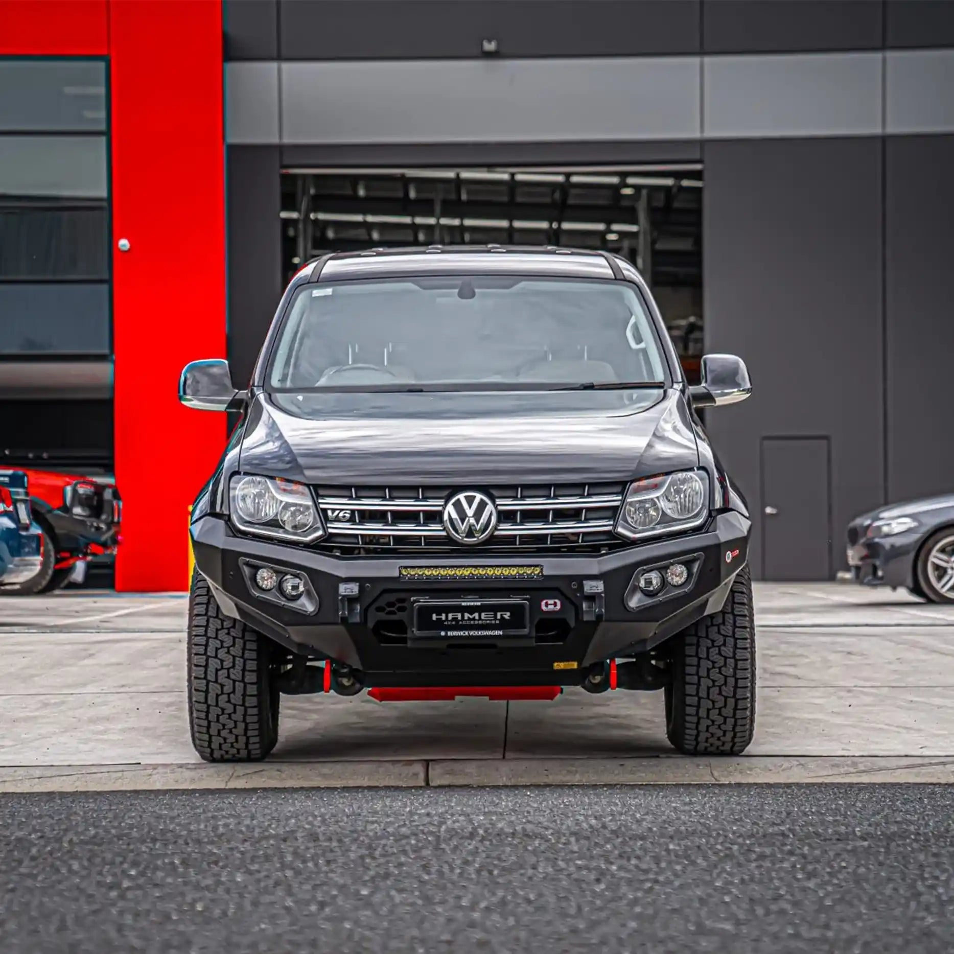 Angled front shot of Volkswagen Amarok fitted with Hamer King Series Bull Bar, matte black powder-coated finish, winch compatible up to 12,000 lb.