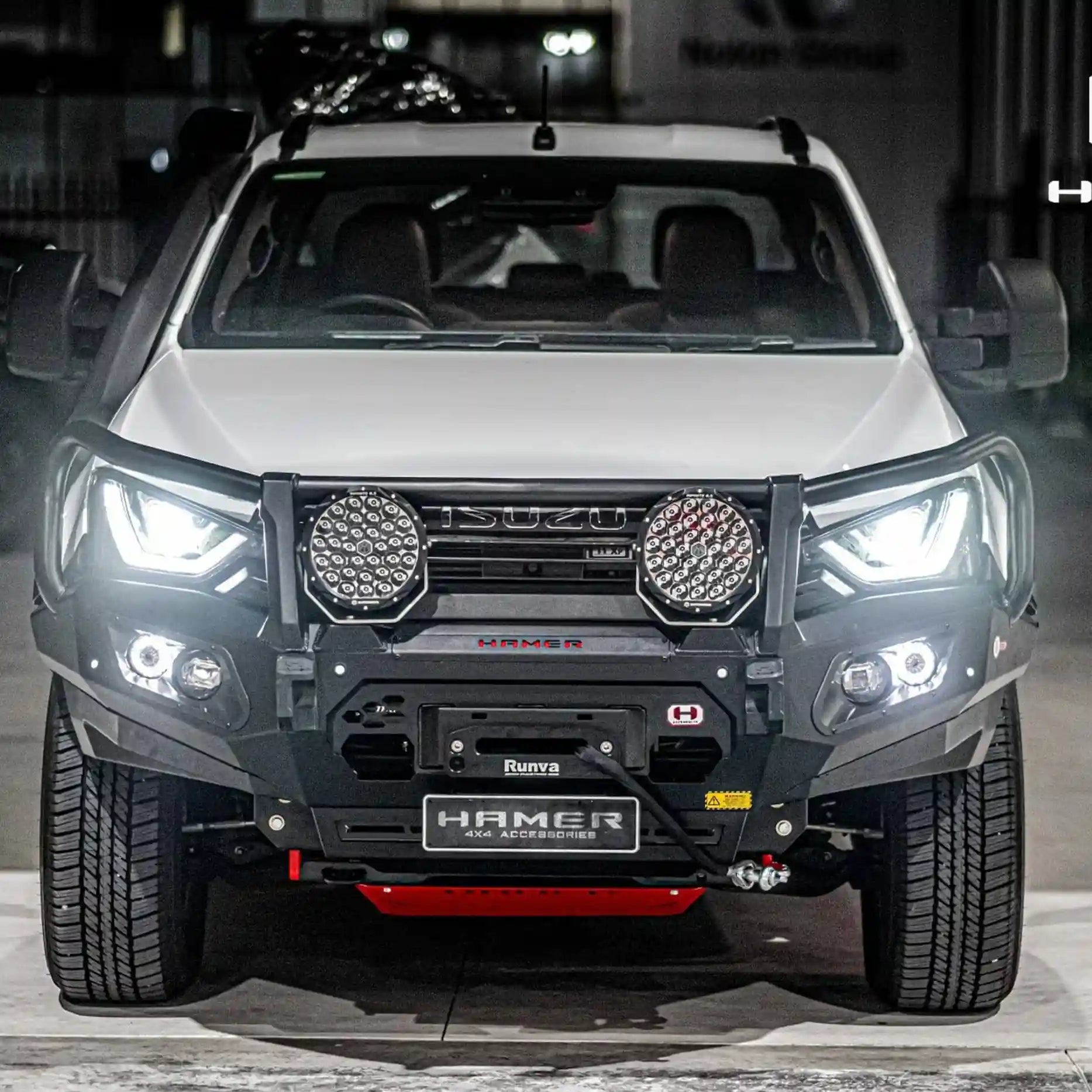 Angled front shot of the Hamer King Series Plus Bull Bar on the Isuzu D-Max 2021–2024, showcasing ADR compliance, winch compatibility, and European E-Mark certified LED daytime running lights.
