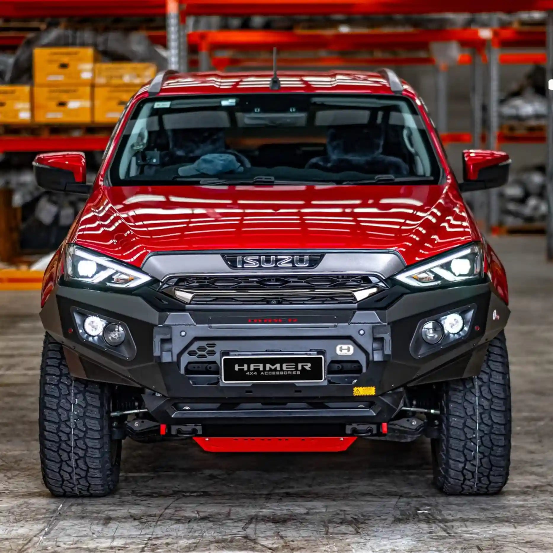 Front view of Isuzu MU-X 2016–2020 fitted with the Hamer King Series Plus Bull Bar, featuring a matte black powder-coated finish, ADR / Airbag compliance, and integrated LED lights for safety and visibility.