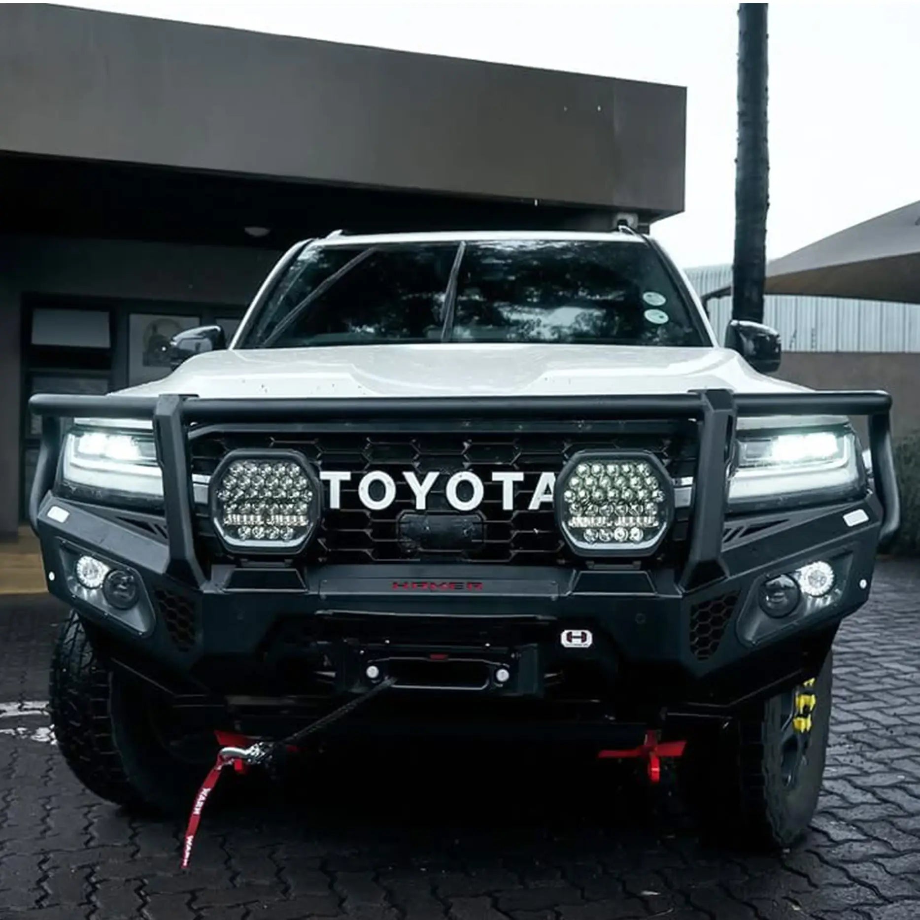 Front angled view of Toyota Landcruiser 300 with Hamer King Series Plus Bull Bar, matte black steel, E-Mark LED lights, built for toughness.