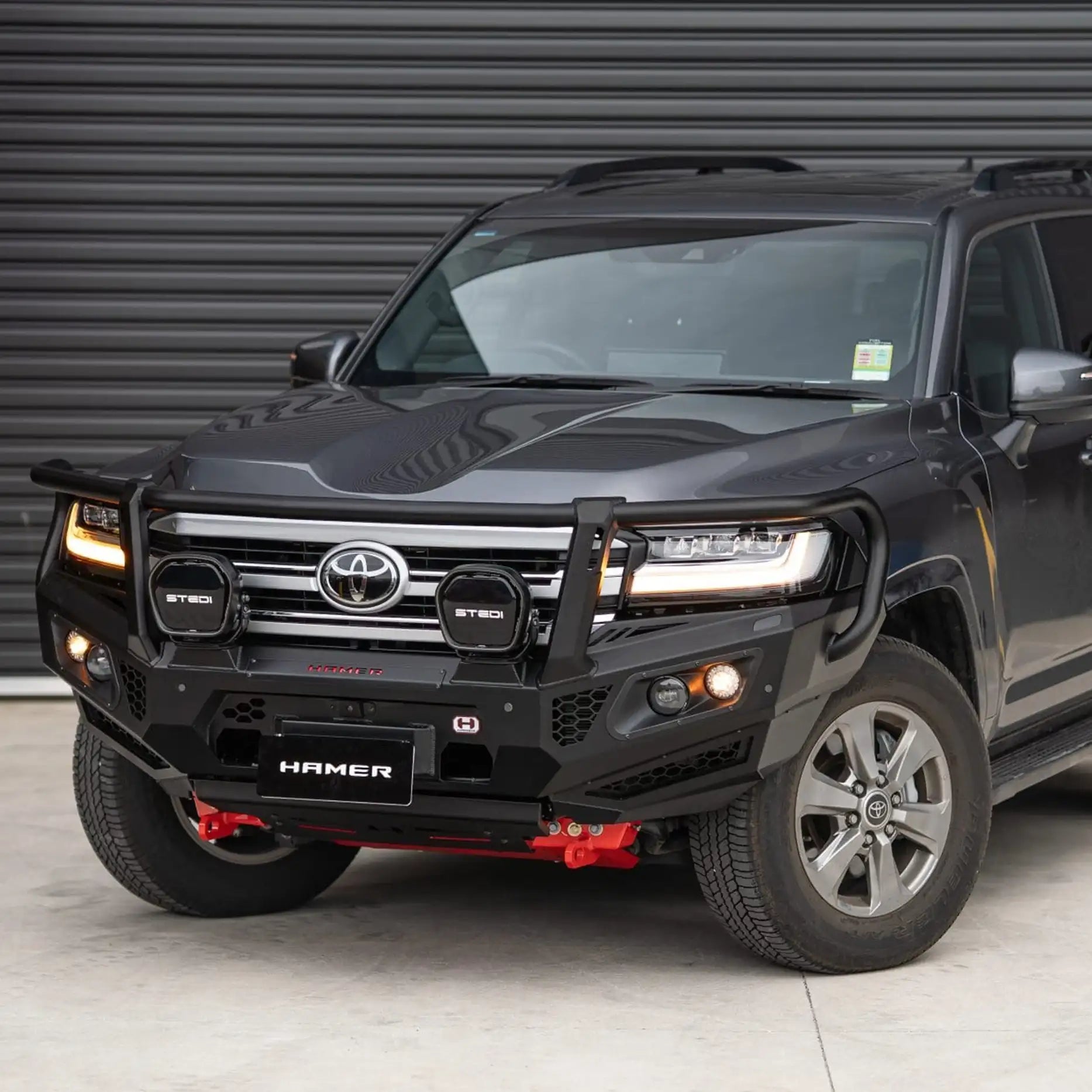 Right view of Landcruiser 300 fitted with Hamer King Series Plus Bull Bar, durable matte black steel with recovery points and LED lighting.