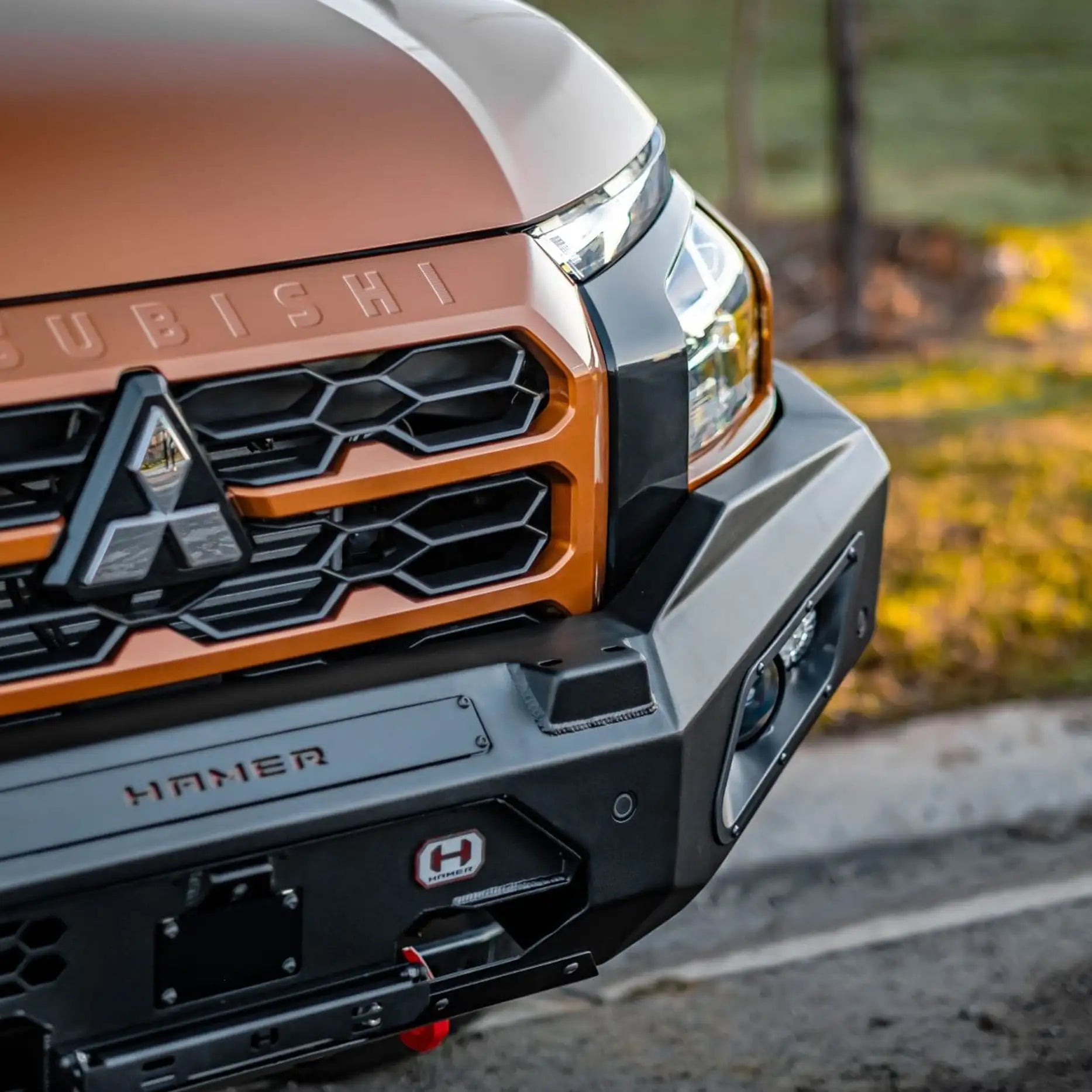 Left closeup angle of Mitsubishi Triton MV (2024–Present) with Hamer King Bull Bar, showing sleek integration, camera relocation, and premium durability.