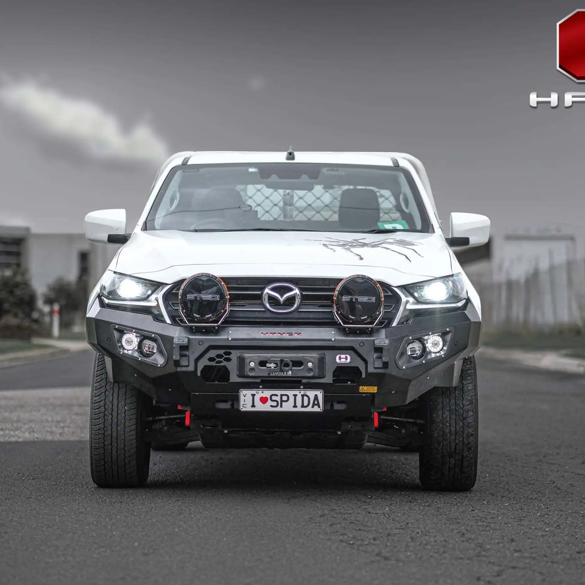 Close front angle of Hamer King Series Bull Bar on Mazda BT-50 (2021–2024), showing LED lighting, recovery points and tough steel build.