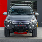 Front view of Mitsubishi Pajero Sport QE (2016–2019) equipped with Hamer King Series Bull Bar, featuring 3mm steel strength, winch compatibility, and integrated LED lights.