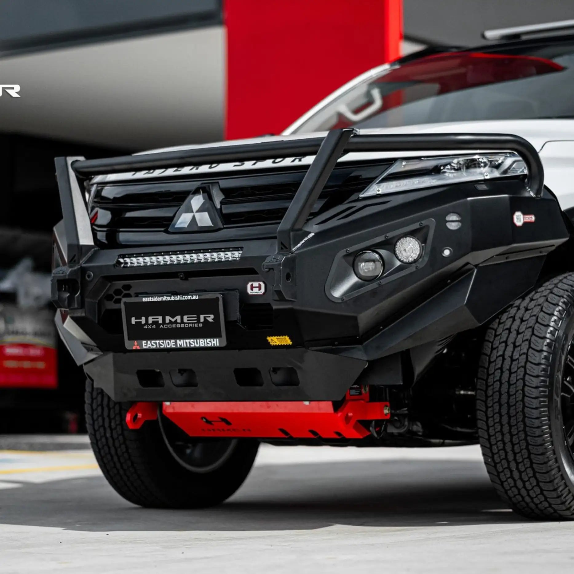Right side view of Pajero Sport QF with Hamer King Plus Bull Bar, sleek matte black finish and durable off-road bumper protection.