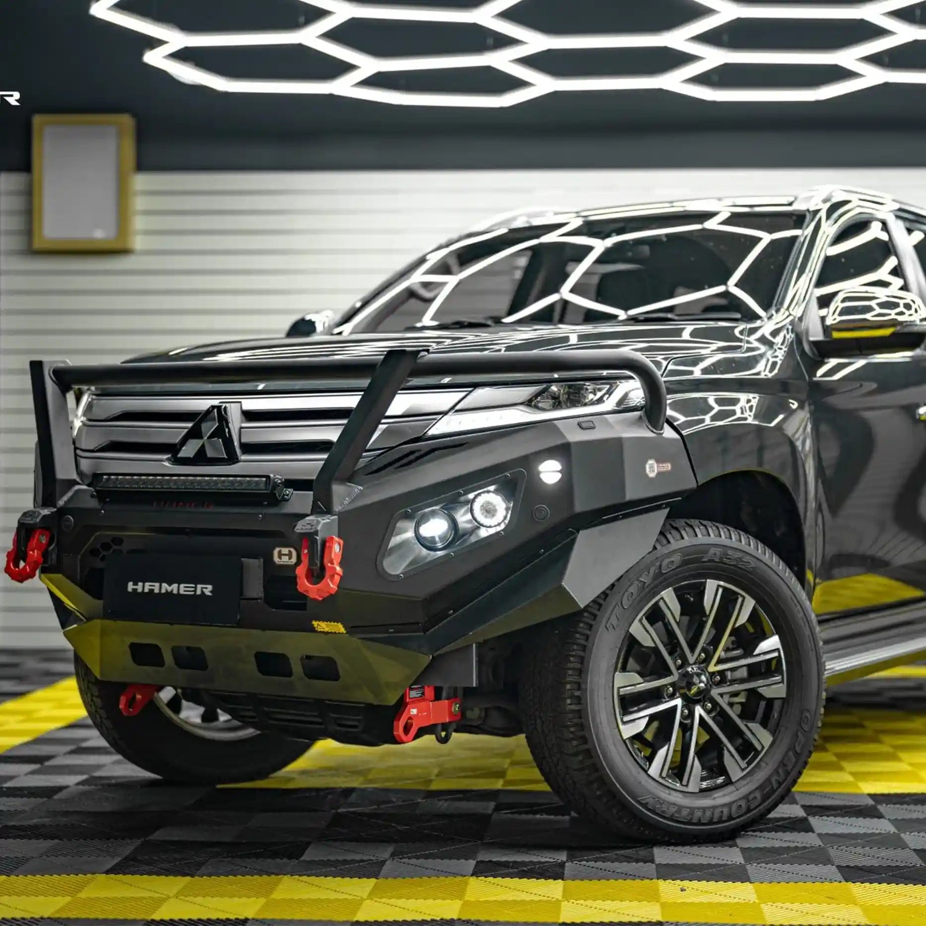 Right side angle of Pajero Sport QG 2024 fitted with Hamer King Plus Bull Bar, strong steel protection with sleek integrated style.