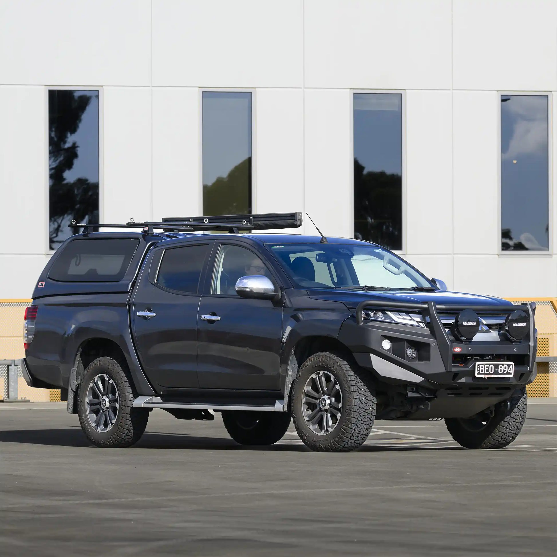 Left side installed view of Mitsubishi Triton MR with RAXAR looped bull bar, highlighting recovery points, fog light integration, and high-lift jacking points. Built tough for both worksites and off-road adventures with Elevated 4x4.