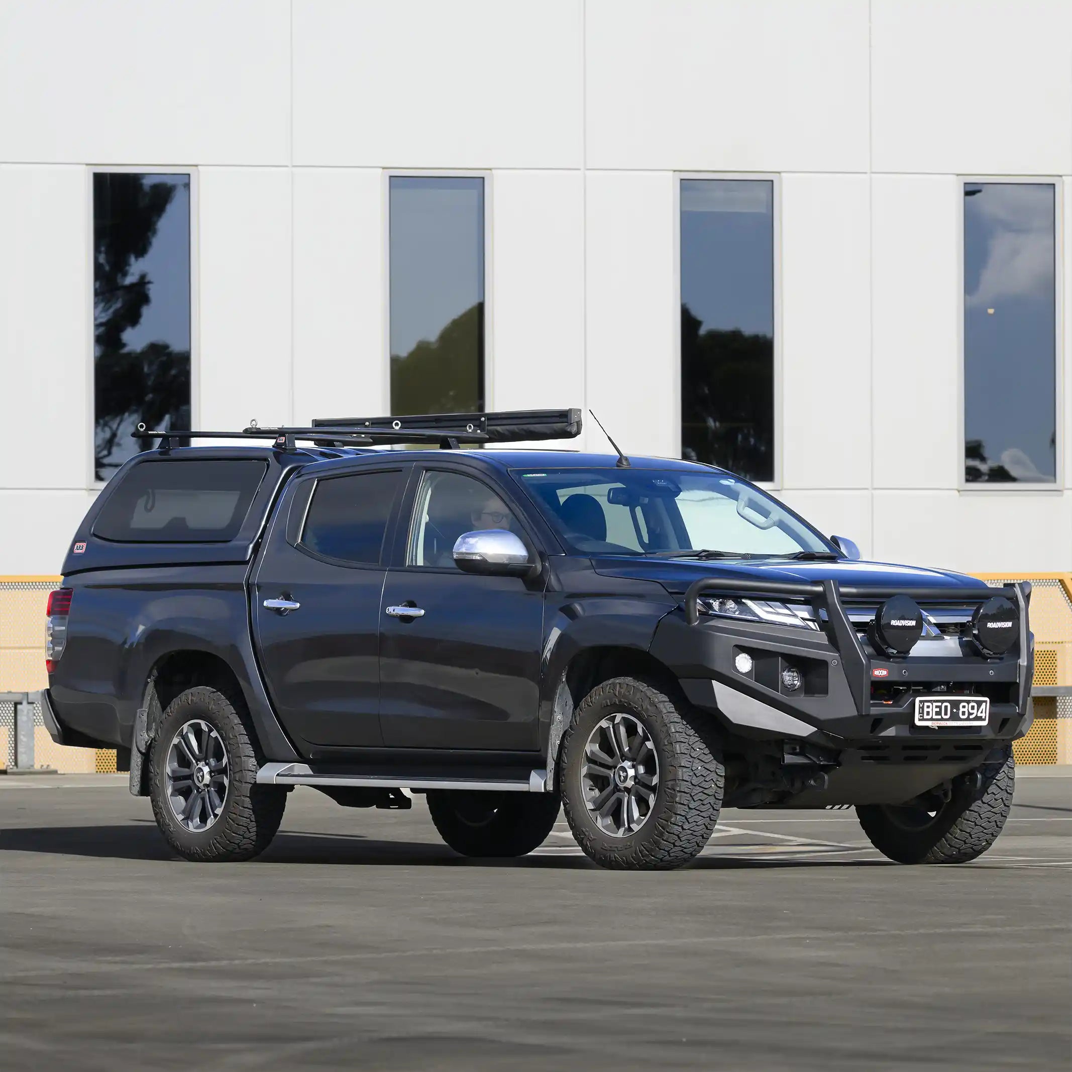 Left side installed view of Mitsubishi Triton MR with RAXAR looped bull bar, highlighting recovery points, fog light integration, and high-lift jacking points. Built tough for both worksites and off-road adventures with Elevated 4x4.