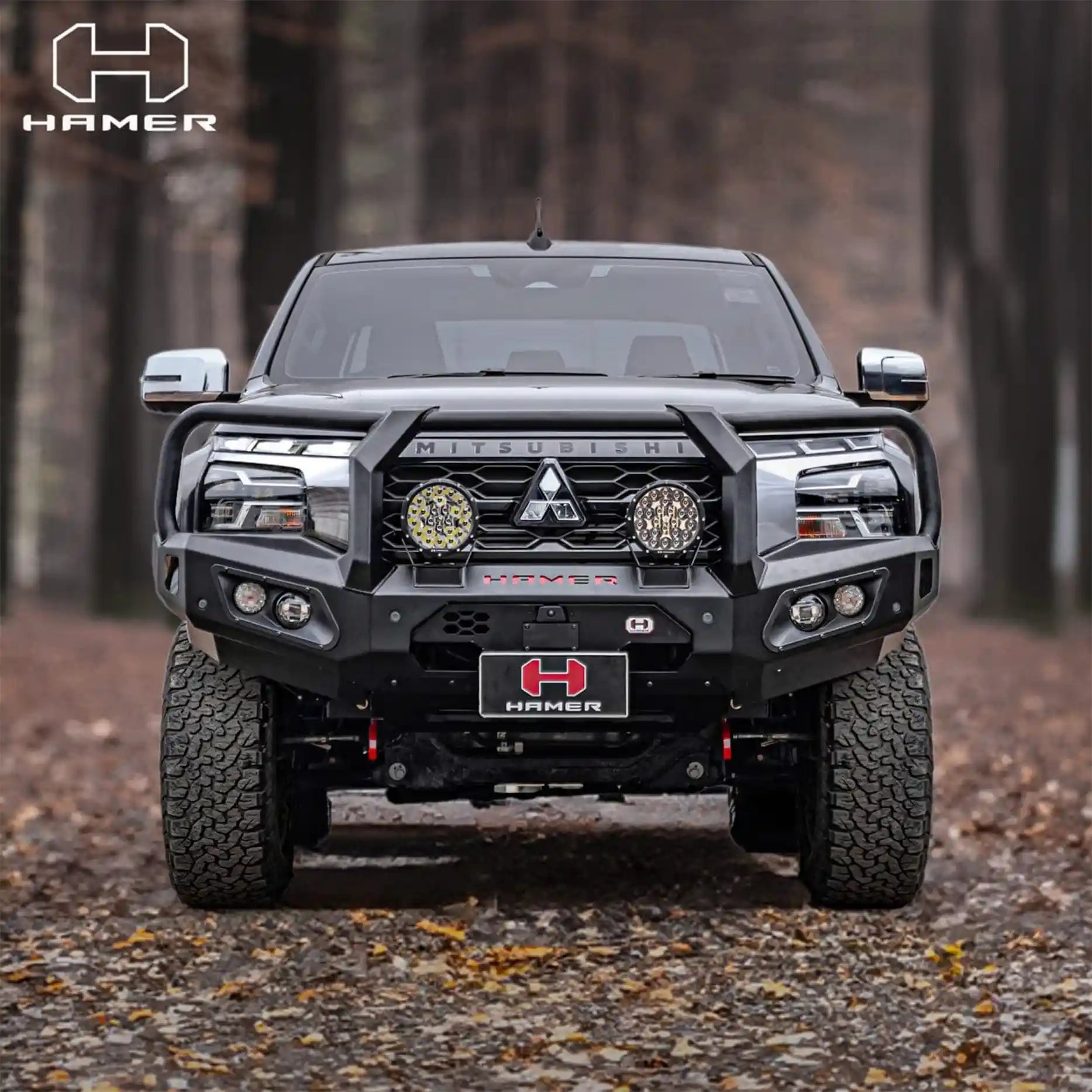 Front view of Mitsubishi Triton MV 2024 with Hamer King Plus Bull Bar, ADR compliant steel bar with LED lights and rugged matte black style.