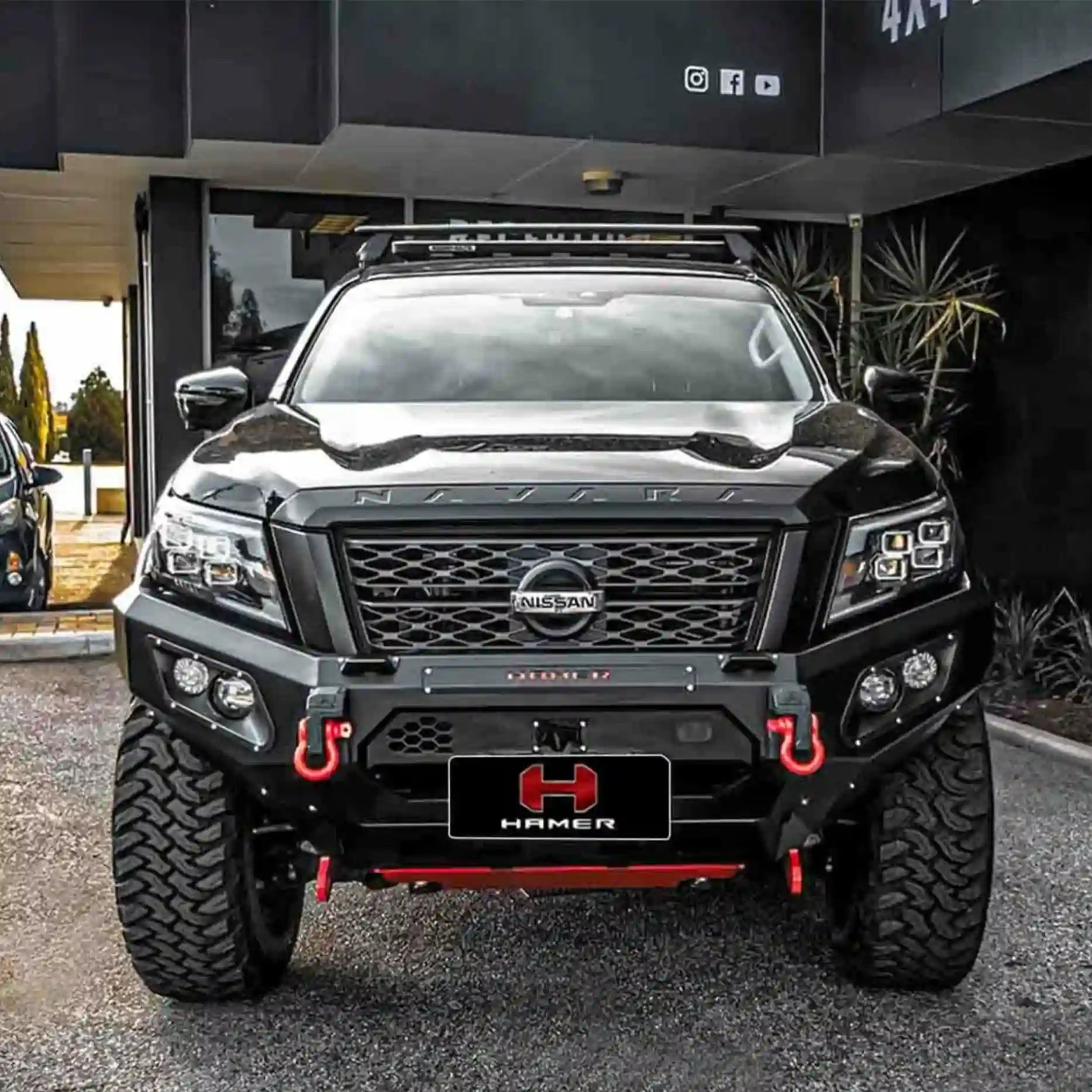 Front view of Nissan Navara (2021–Present) fitted with Hamer King Bull Bar, a heavy-duty matte black bumper replacement with LED lights and recovery points.