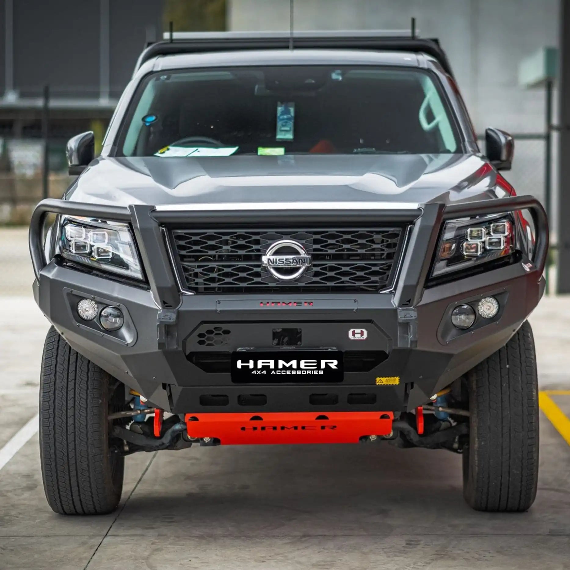 Front view of Nissan Navara 2021 with Hamer King Plus Bull Bar, matte black 3mm steel bumper replacement with integrated LED lighting system.