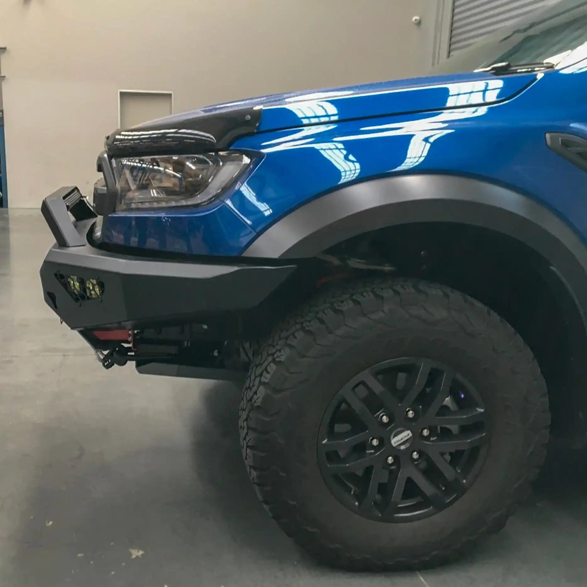 Right-angle installed view of the Offroad Animal Predator Bull Bar on a Ford Ranger Raptor, featuring precision welds and a matte black powder-coated finish. Available at Elevated 4x4 Australia, this high-quality 4WD accessory offers a perfect blend of durability, design, and performance for adventurous drivers.