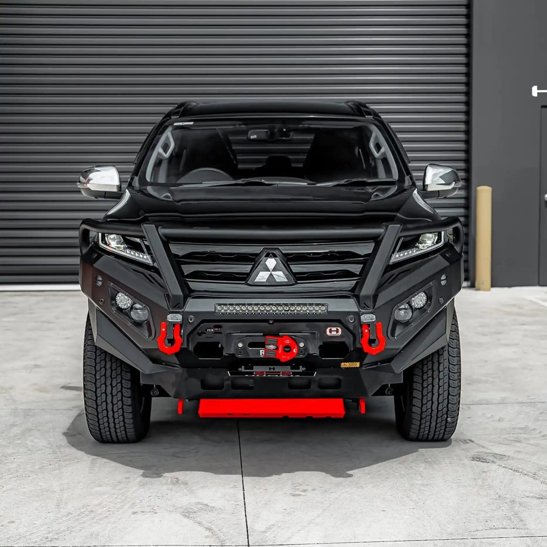 Front view of Mitsubishi Pajero Sport QF with Hamer King Plus Bull Bar, matte black, ADR compliant, and winch compatible design.